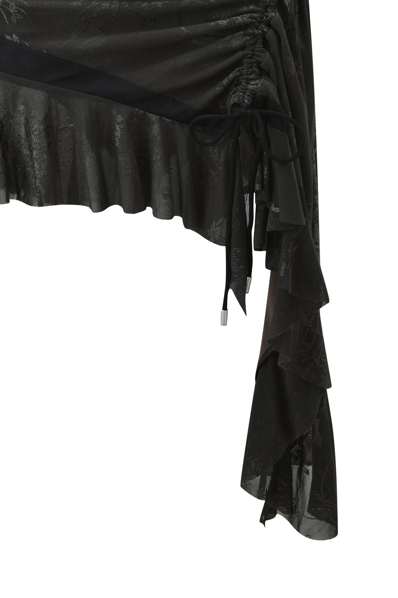 Close-up of the ISOLAE ASYMMETRICAL MINI SKIRT in black by I.AM.GIA, featuring jacquard mesh with a subtle floral pattern, ruffled hem, ruching, a decorative side bow, and a layered asymmetrical draped design.