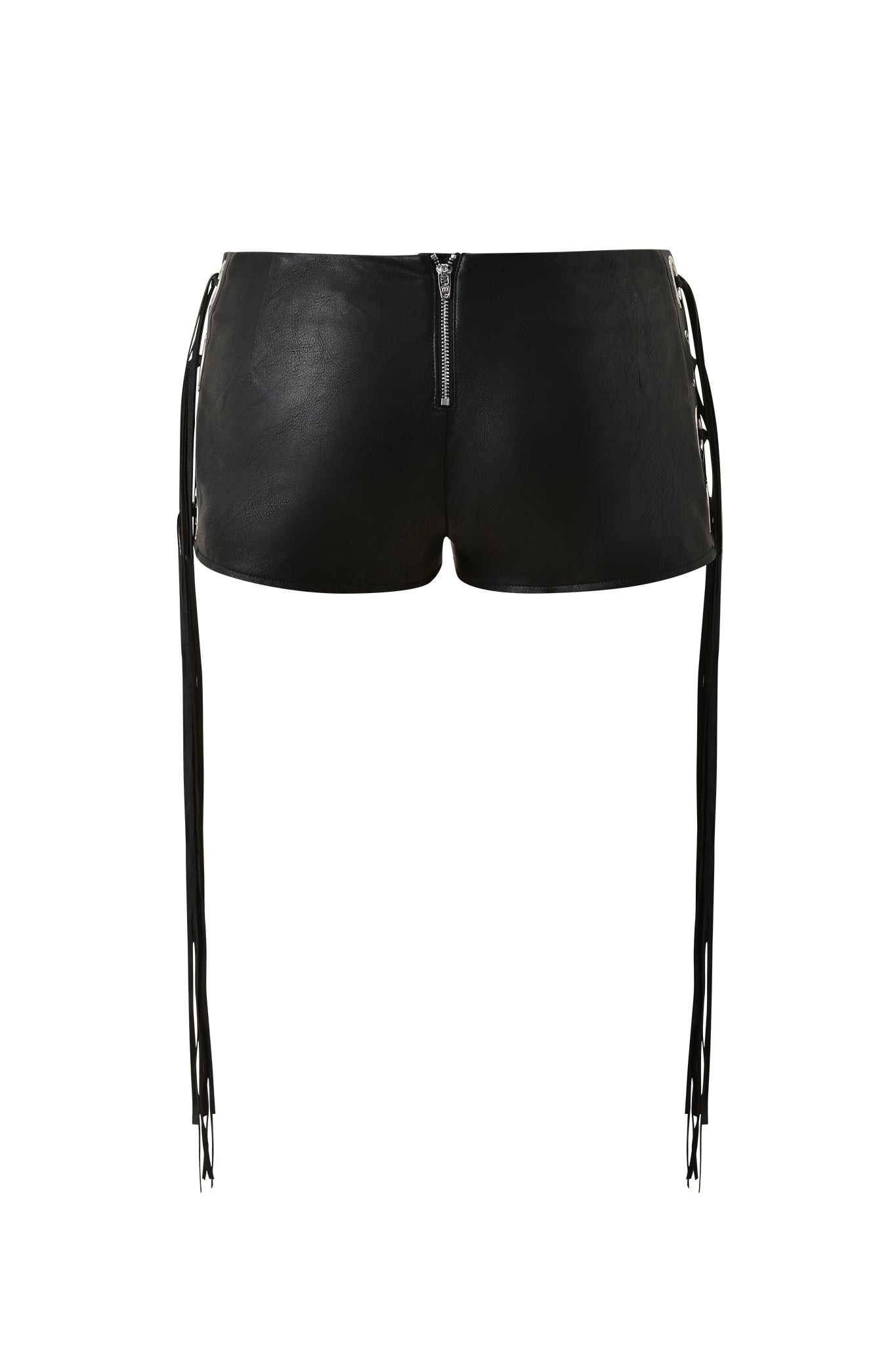 The NURI FRINGE SHORT - BLACK by I.AM.GIA features black faux-leather, side lace-up details, long fringe straps, a visible back zipper, and a mid-rise waist, shown against a plain white background.