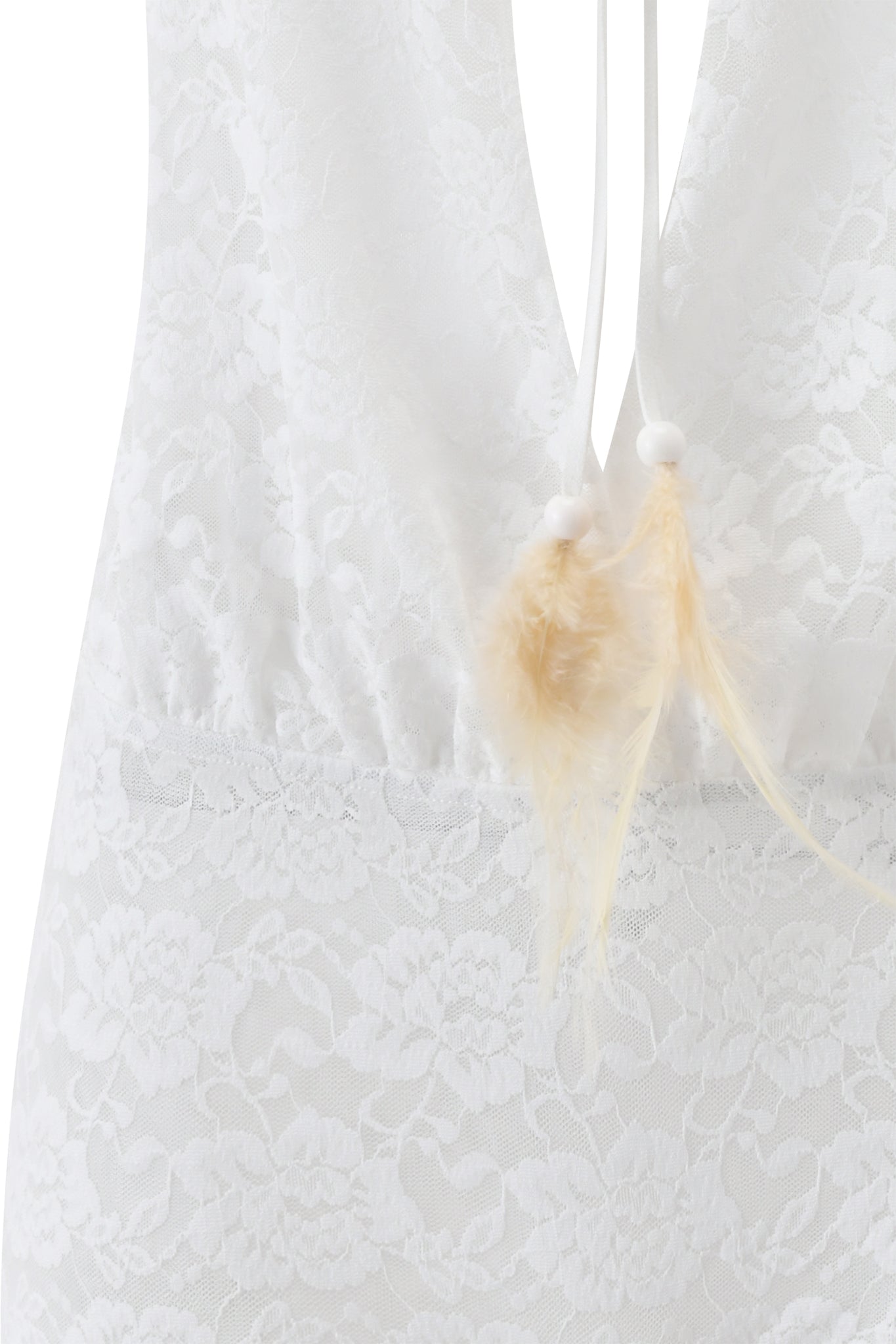 Close-up of the PHERN PLAYSUIT - WHITE by I.AM.GIA, showcasing delicate white floral lace with beige feathers and white bead accents hanging from thin strings at the back.