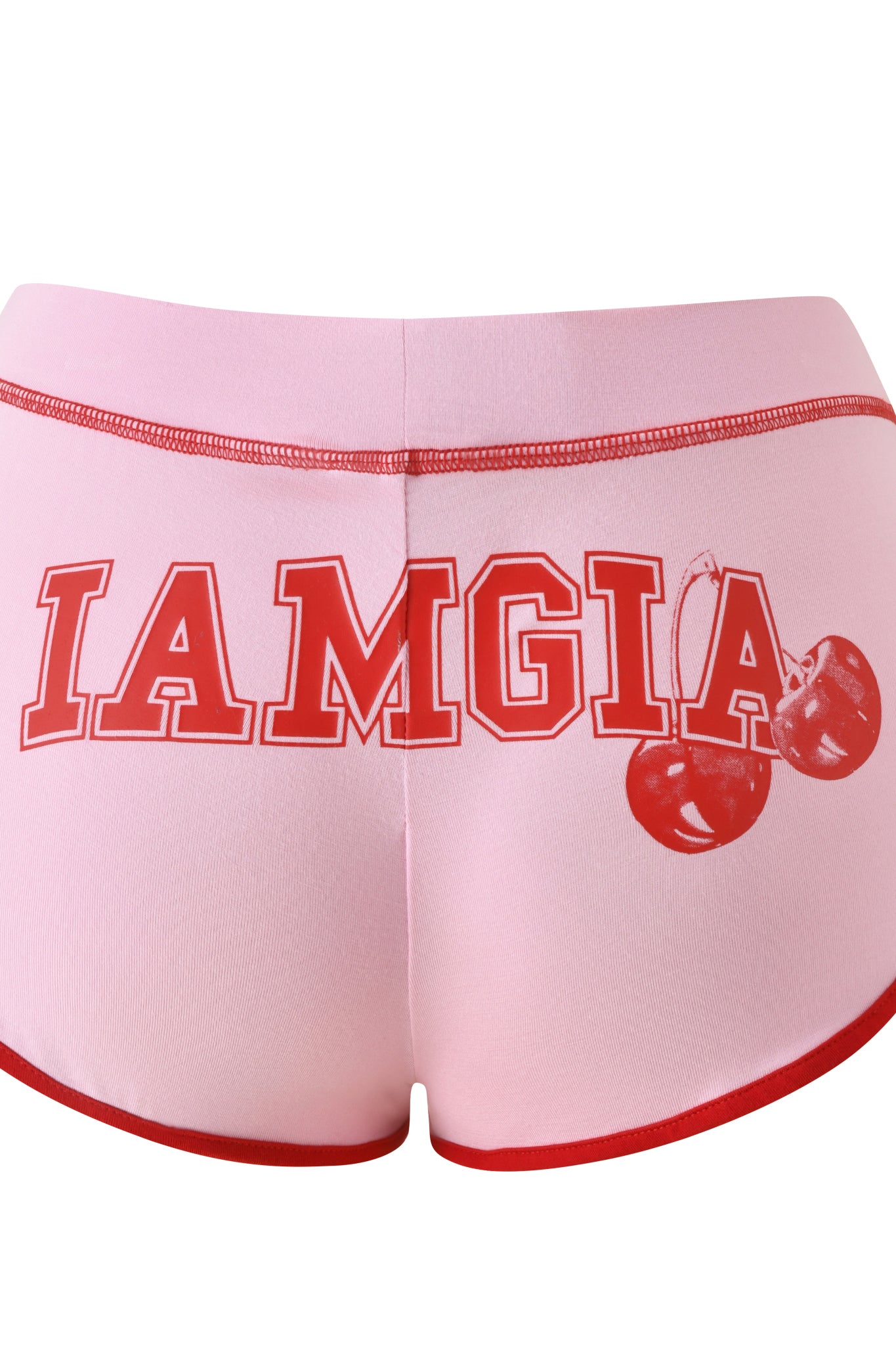 The BLARE DOLPHIN SHORT - BABY PINK by I.AM.GIA features a playful pink base with red trim, bold red "IAMGIA" block lettering across the back, and a cherry illustration on the right side. Inspired by classic bamboo dolphin shorts, these standout shorts effortlessly blend comfort with trend-forward style.