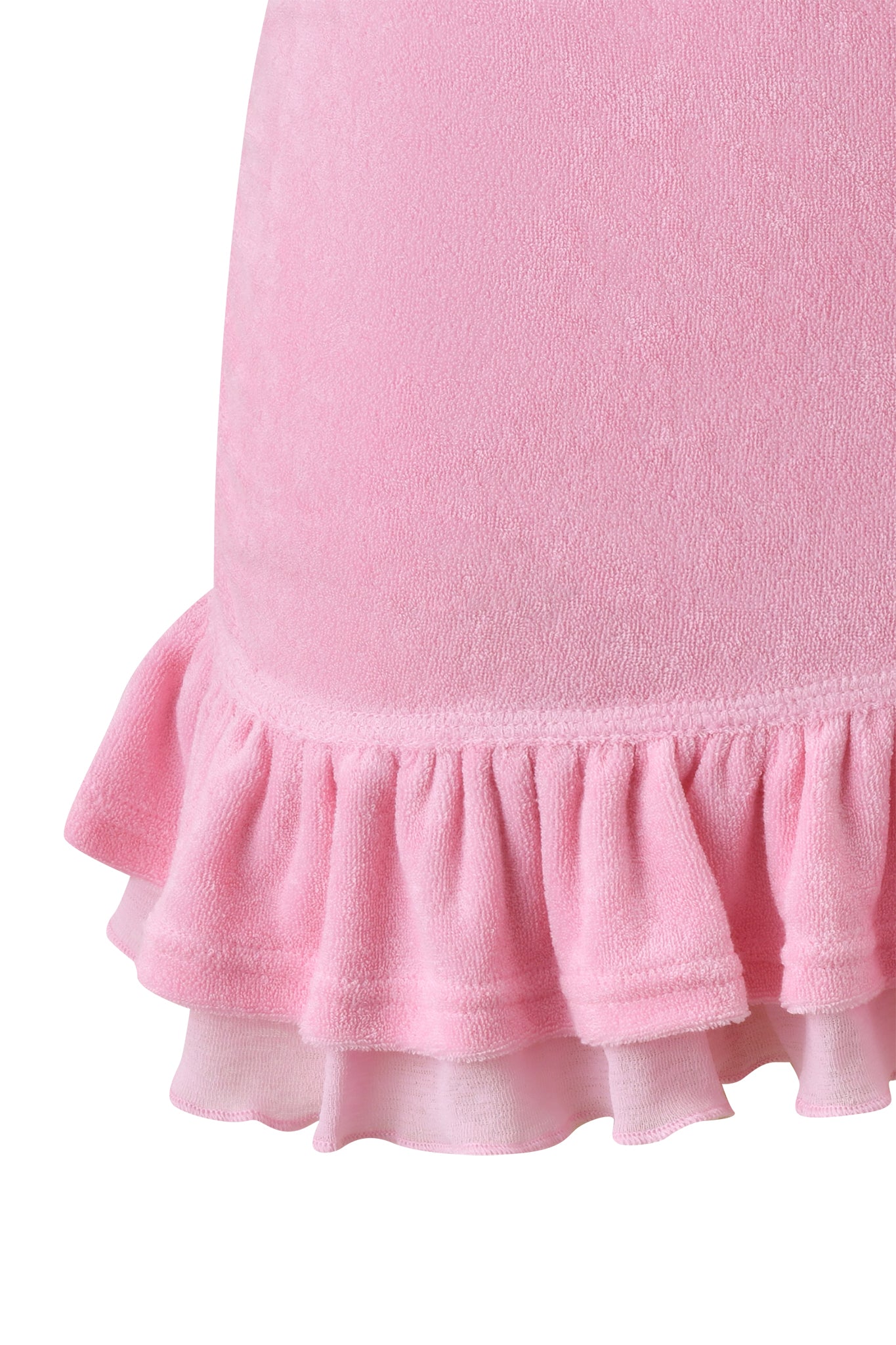 Close-up of the BRIELLE TERRY MINI SKIRT by I.AM.GIA in pink, featuring a double-layered ruffled hem with soft terry cloth on top and a sheer material underneath.