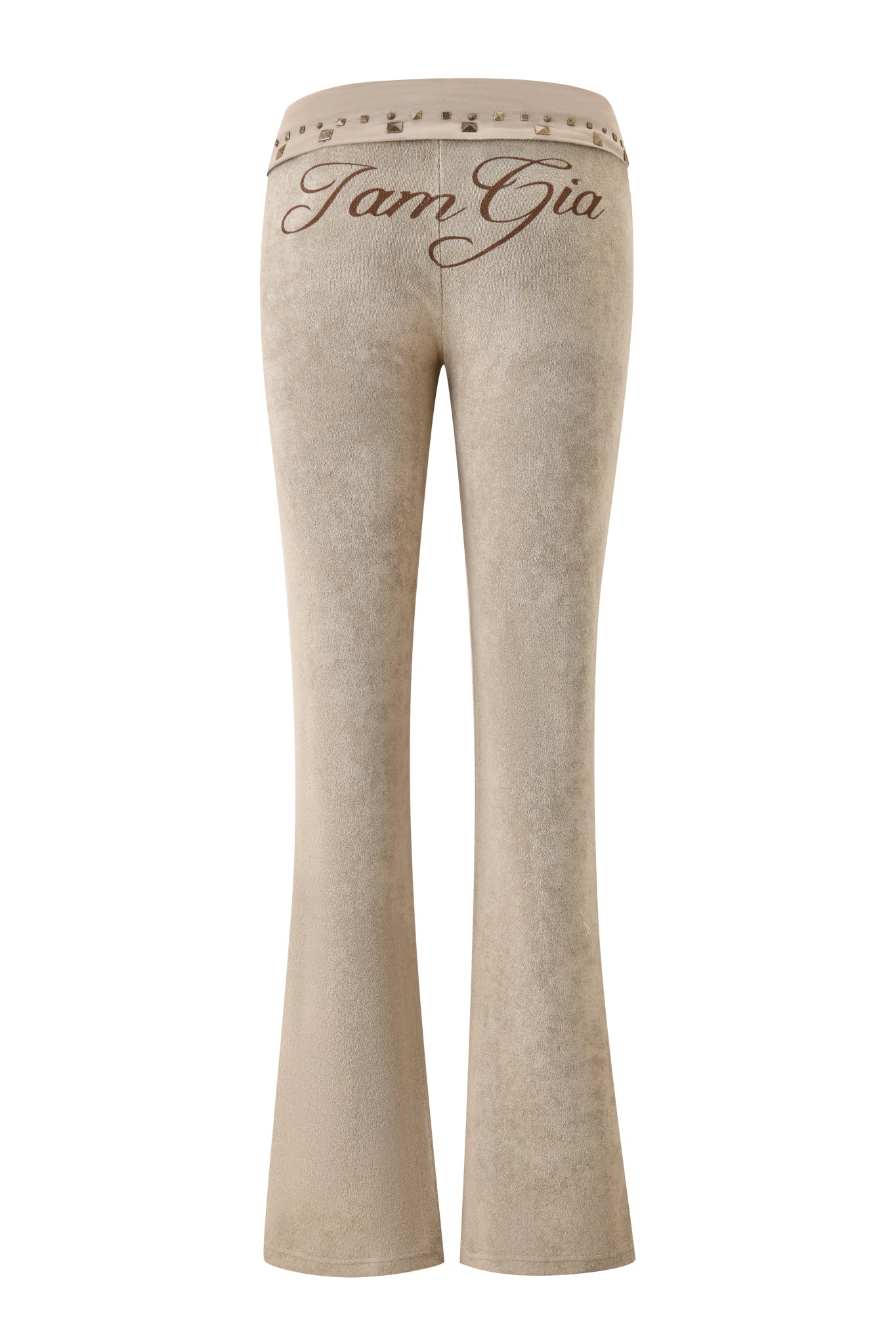 The BLARE STUDDED TERRY PANT - STONE by I.AM.GIA is shown from the back, featuring "Tam Gia" in cursive on the waistband and metallic studs along the edge for a signature brand style.