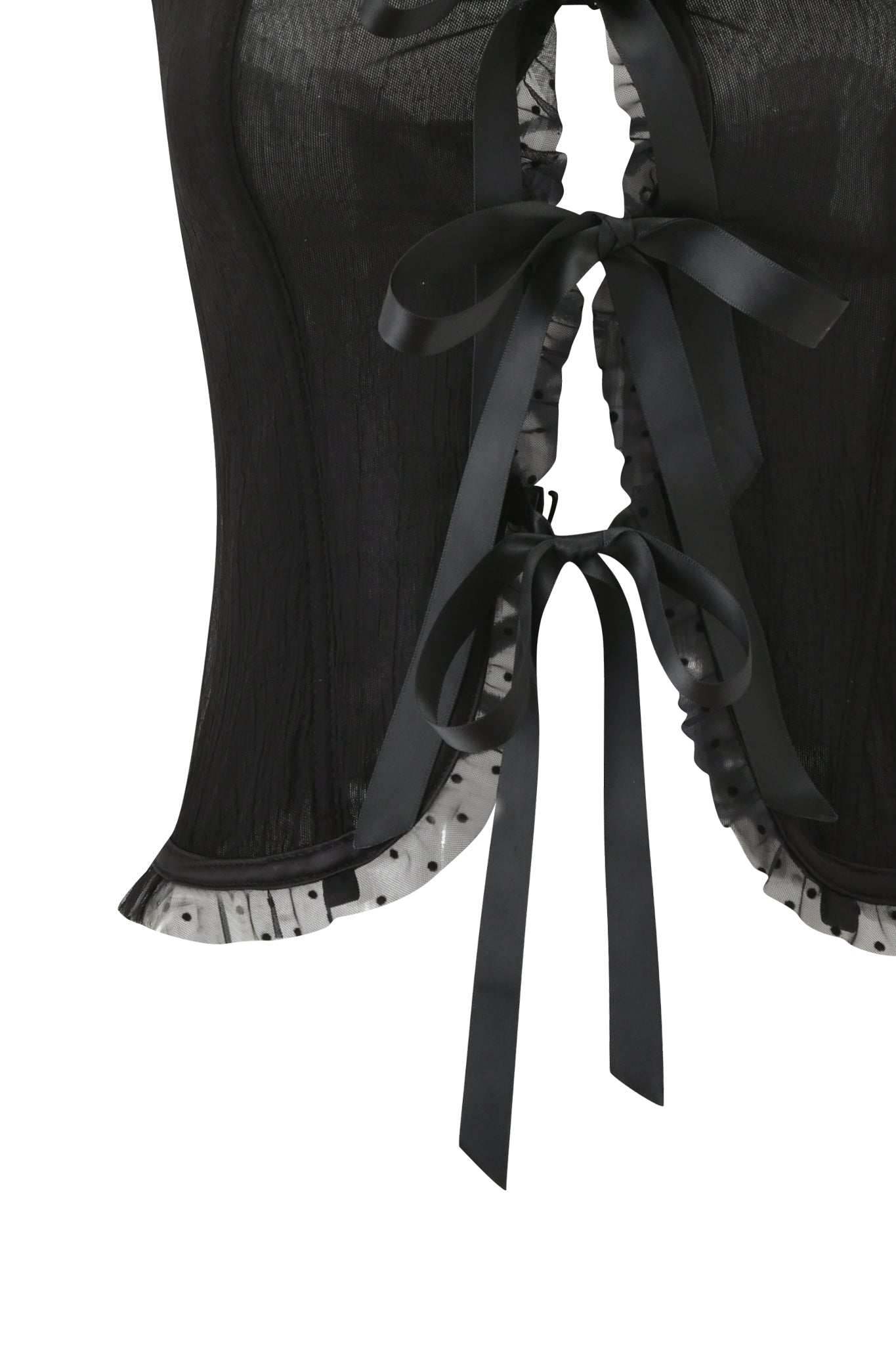 Close-up of the I.AM.GIA CIRA CORSET - BLACK, featuring strapless black sheer fabric, white polka dot ruffle trim, and black satin ribbon lacing up the back with two bows.