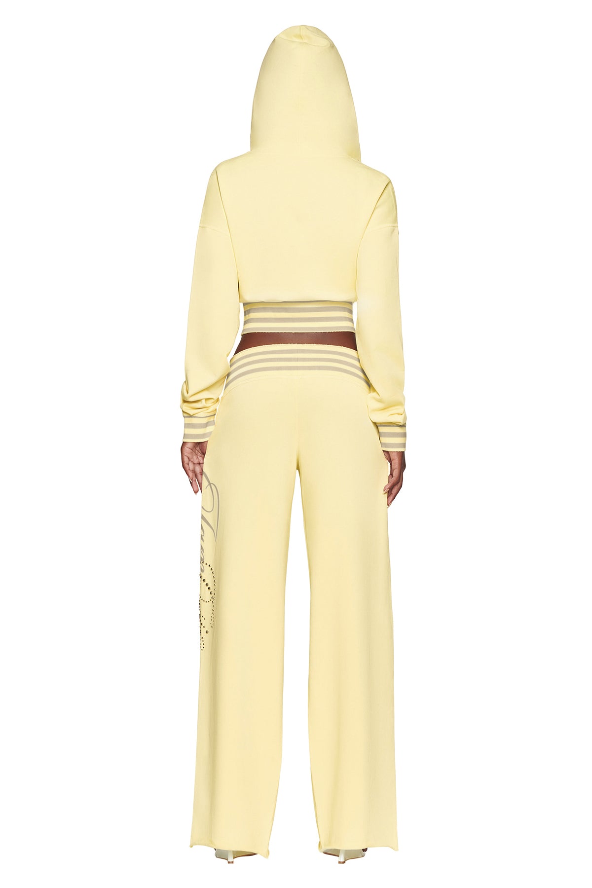 A person is shown from the back standing against a white background, wearing the I.AM.GIA VEDA JACKET in yellow, paired with matching wide-leg pants.