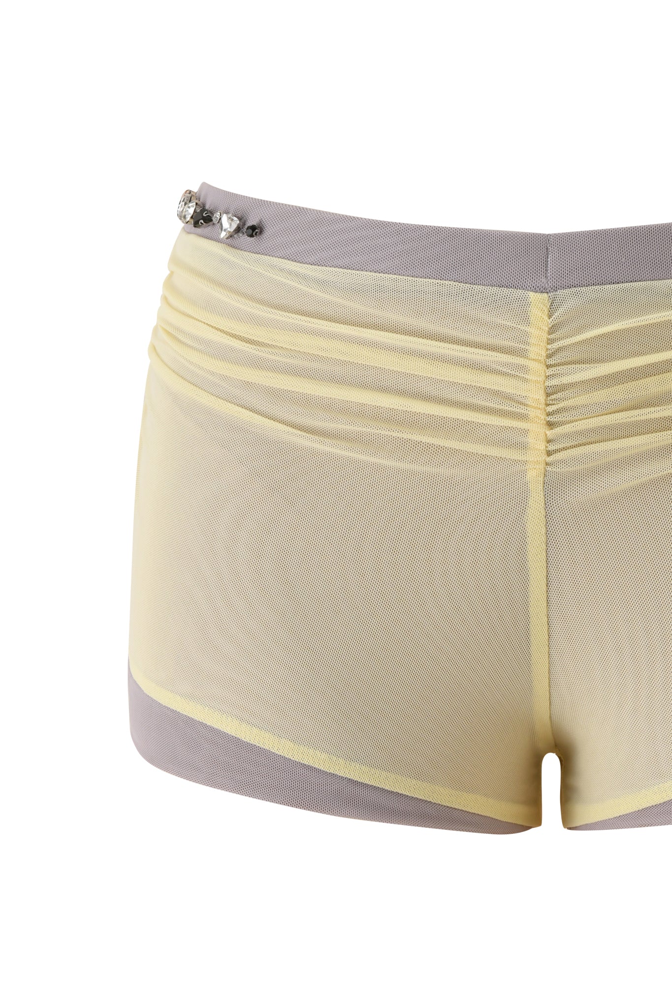 The I.AM.GIA AMATHA SHORT in butter yellow features sheer mesh fabric, a light gray waistband and hem, decorative jewels on the left waistband, and a flattering bodycon fit.