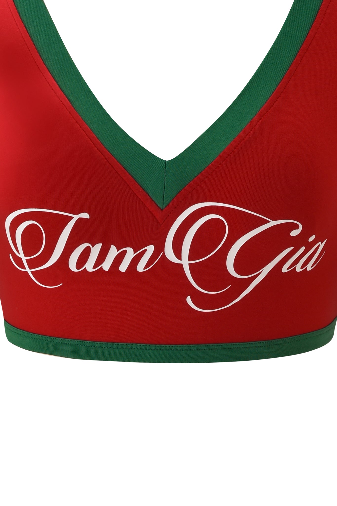 Close-up of the BLARE SPORT CROP TEE AND HEADBAND - CRIMSON by I.AM.GIA, featuring a red ultra-cropped v-neck crop top with green trim and "I am Gia" in white cursive across the chest.