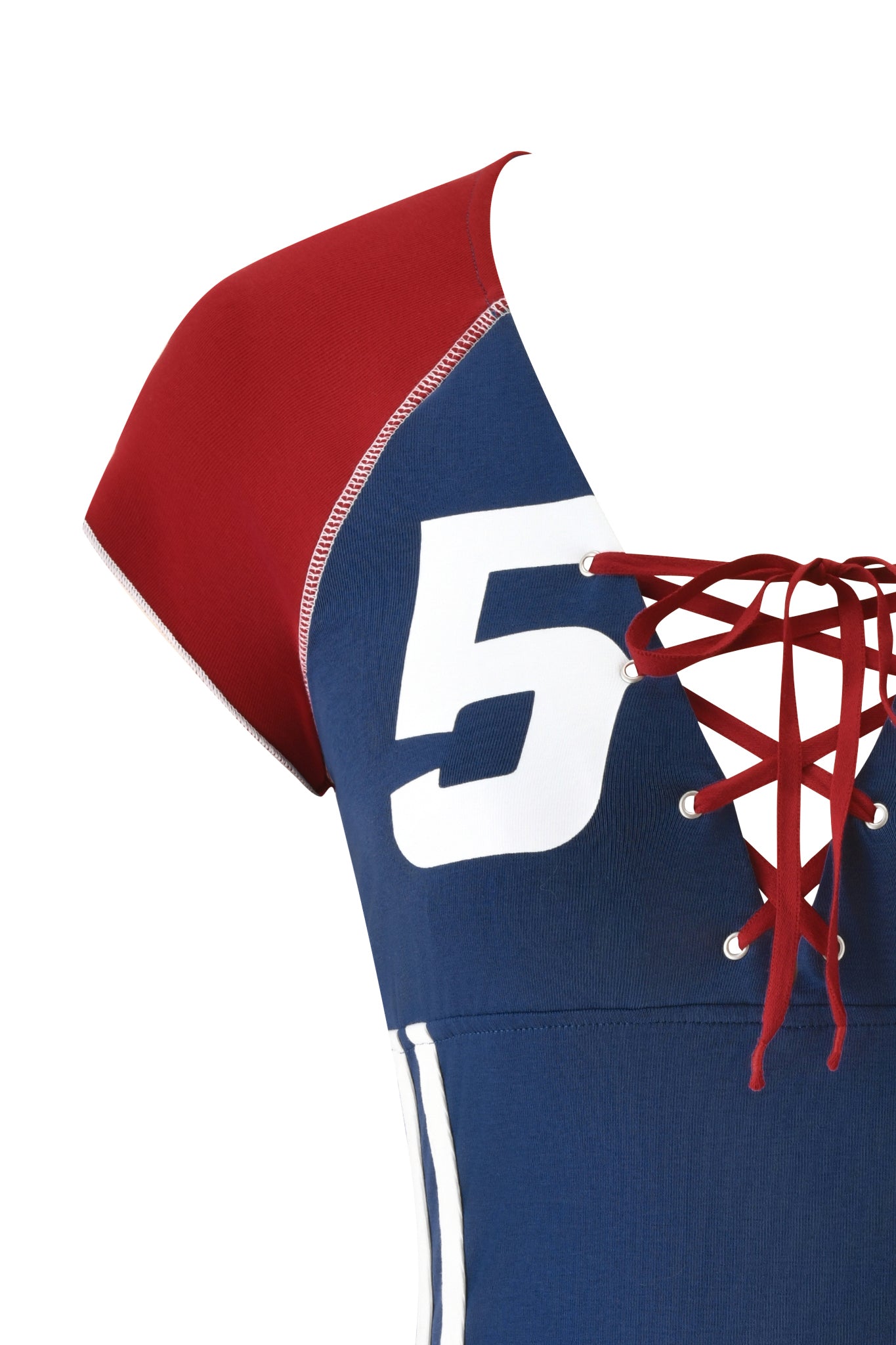 Close-up of the I.AM.GIA NOVIA LACE-UP T-SHIRT AND HEADBAND in navy, inspired by a stretch cotton soccer jersey with a red lace-up front, white side stripe, and vibrant blue body with bright red sleeves and laces.