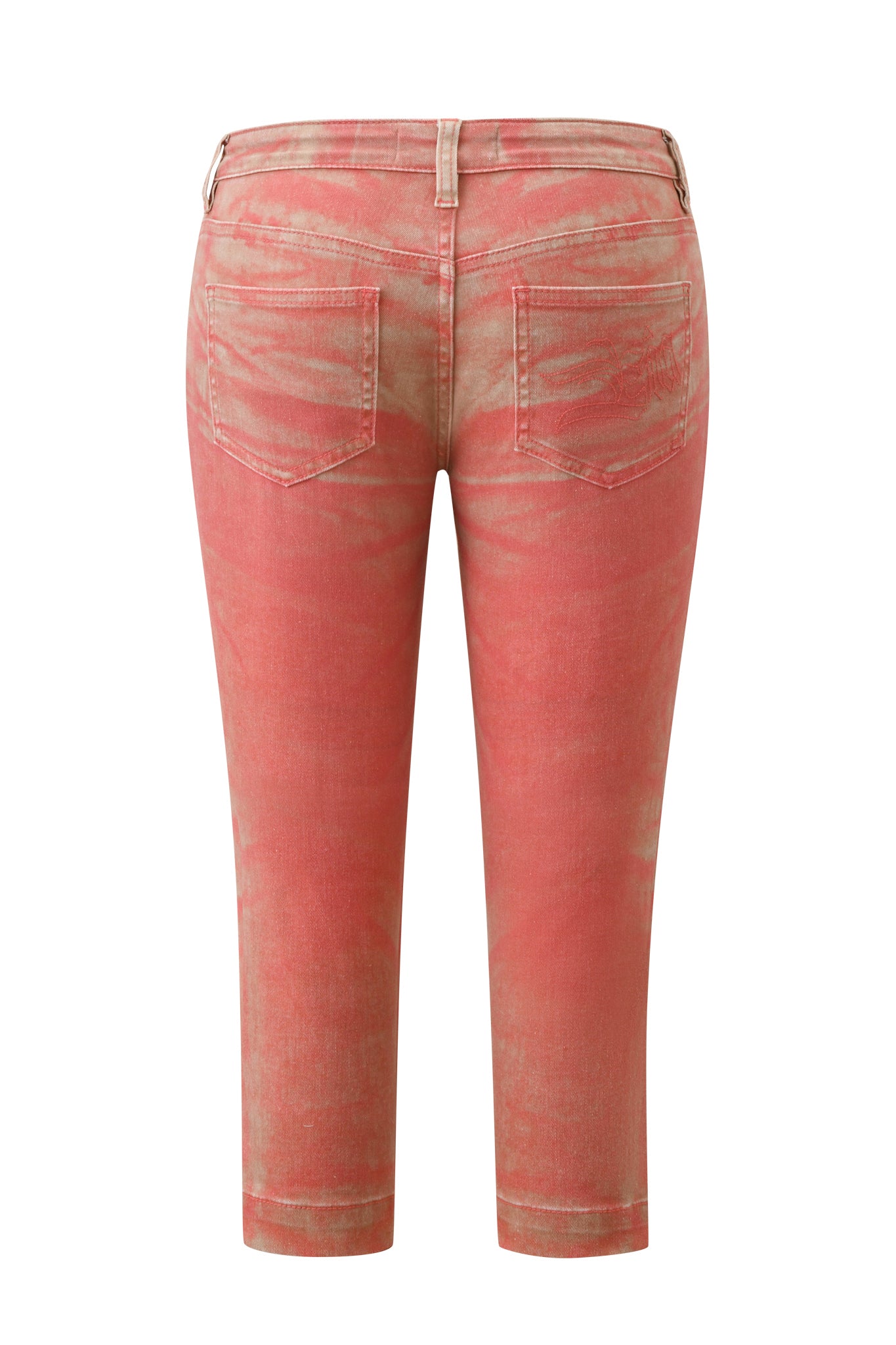 Back view of the SUNSET CAPRI JEAN - PEACH by I.AM.GIA, featuring a cropped capri silhouette in stretch denim with a tie-dye coral and beige design, belt loops, two back pockets, and all-over faded detailing.