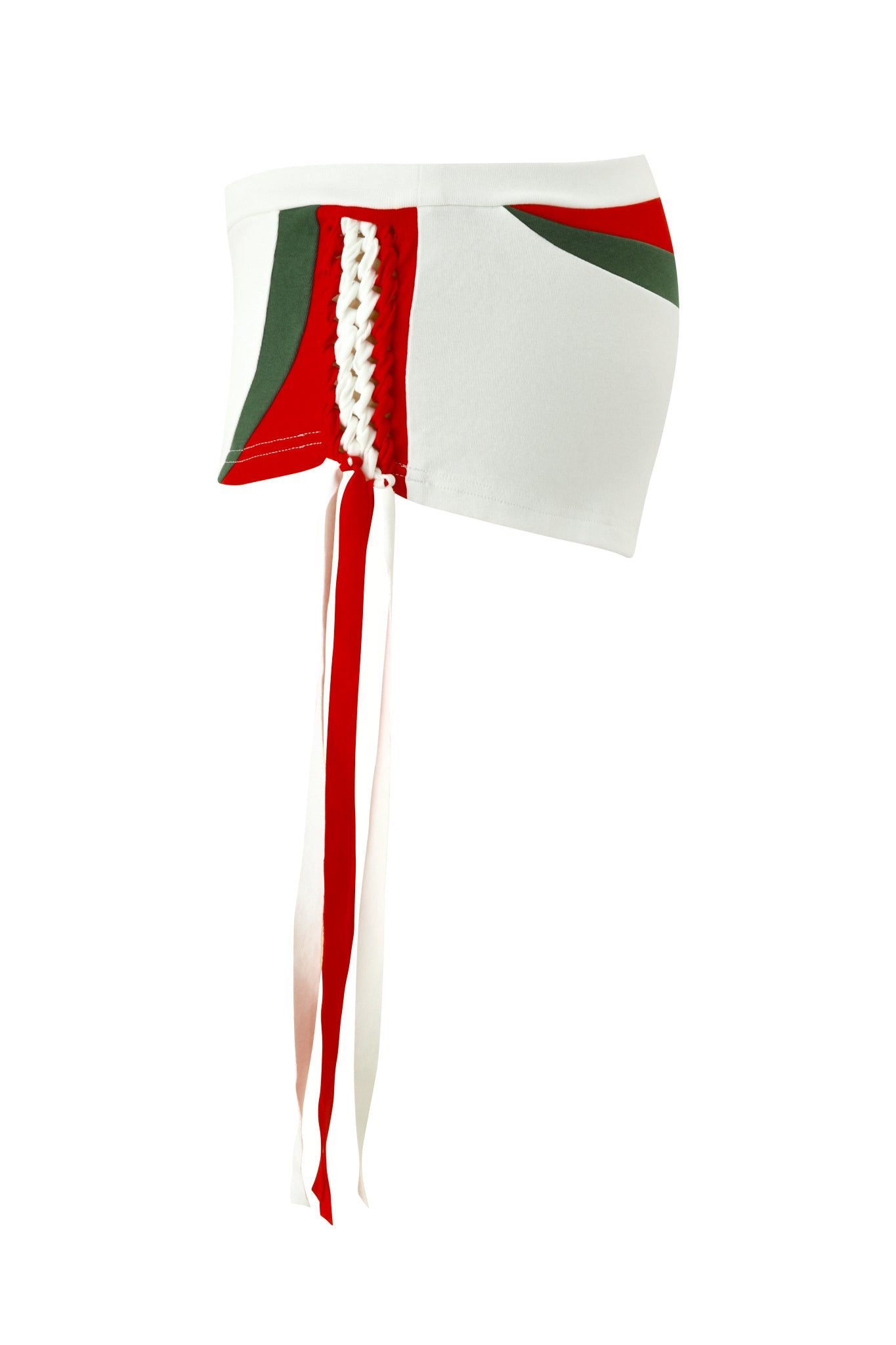 A white asymmetrical mini skirt with green and red panels, side lacing, and long ribbon ties—pair it with I.AM.GIA's NOVIA MICRO SPORT SHORT in white for a bold, modern look.