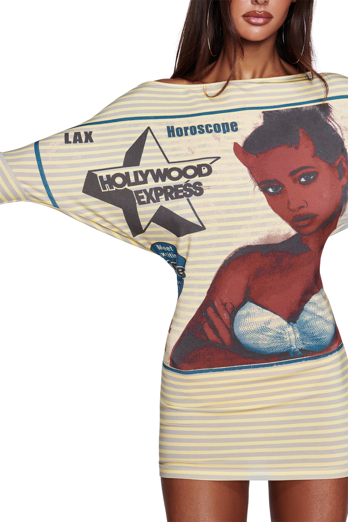 A woman wears the I.AM.GIA T-REX GISELLE OFF SHOULDER MINI DRESS in yellow, an off-shoulder batwing style featuring bold stripes and a striking graphic of a woman, a star, and text that reads “Hollywood Express,” “Horoscope,” and “LAX.” Only the lower part of her face and arm are visible.