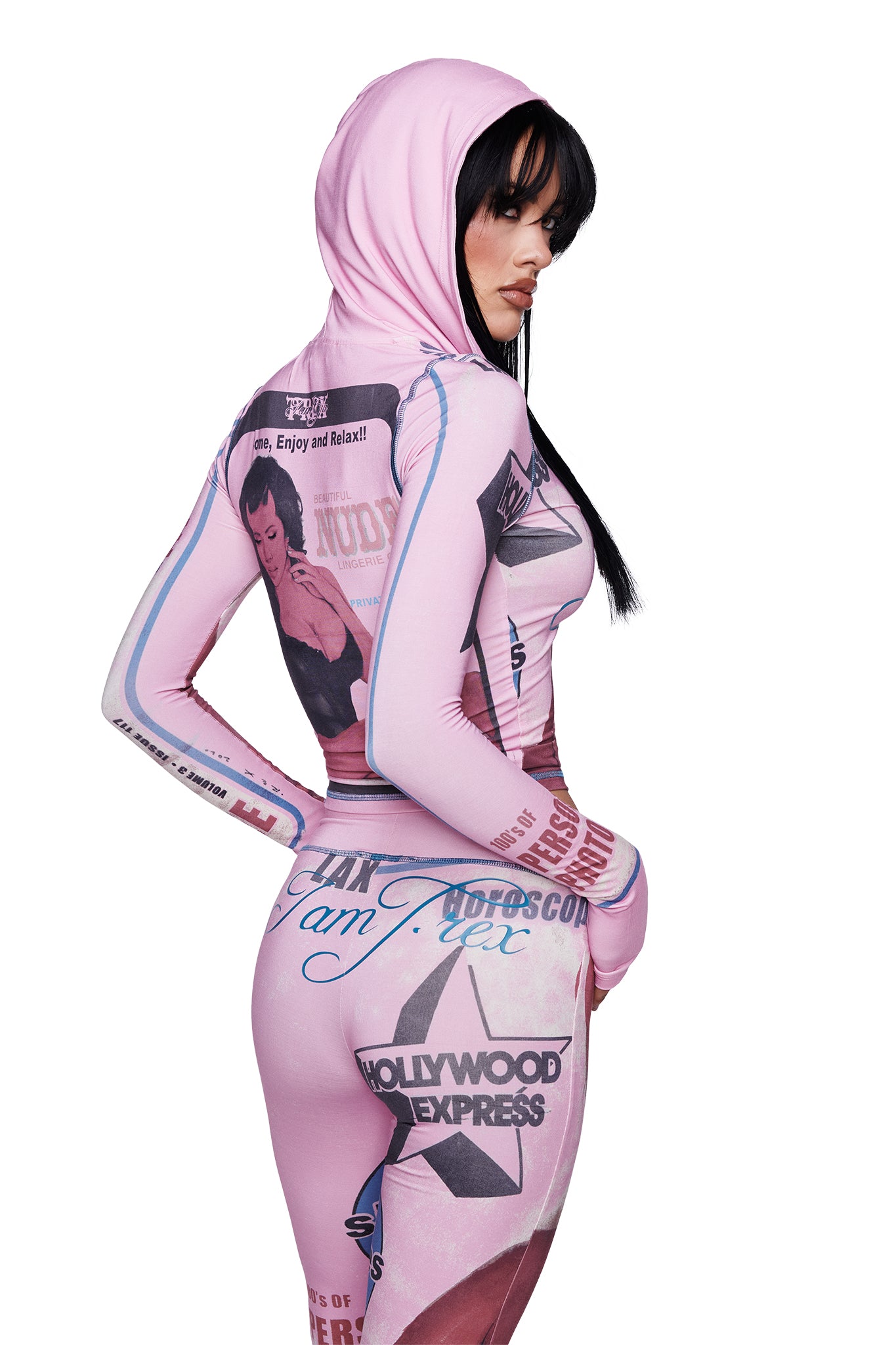 A woman models the I.AM.GIA T-REX BLARE HOODIE in pink—a form-fitting piece featuring bold graphic prints and text—with her head turned to the side, highlighting its distinctive placement print design.
