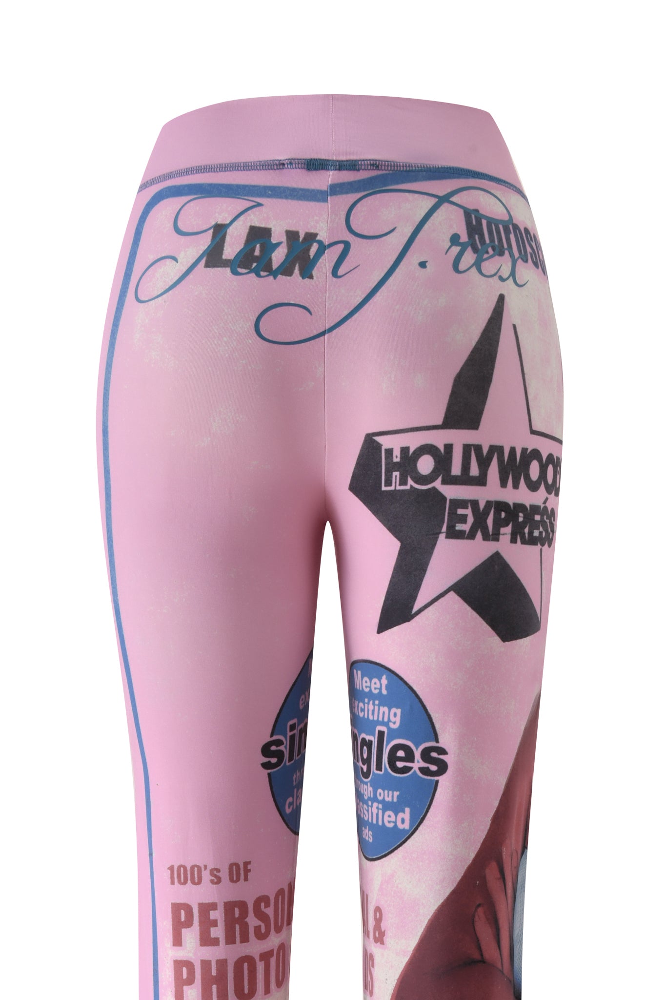 Introducing the T-REX BLARE TRACKPANT - PINK by I.AM.GIA: bold pink trackpants designed in the signature Blare Trackpant style, featuring a comfortable wide elastic waistband. These pants showcase vibrant blue and black text—including phrases like "HOLLYWOOD EXPRESS," "singles," and "100's of PERSONAL PHOTOS"—along with decorative script fonts, T-REX pink print accents, a striking black star graphic, and distinctive streetwear-inspired details.