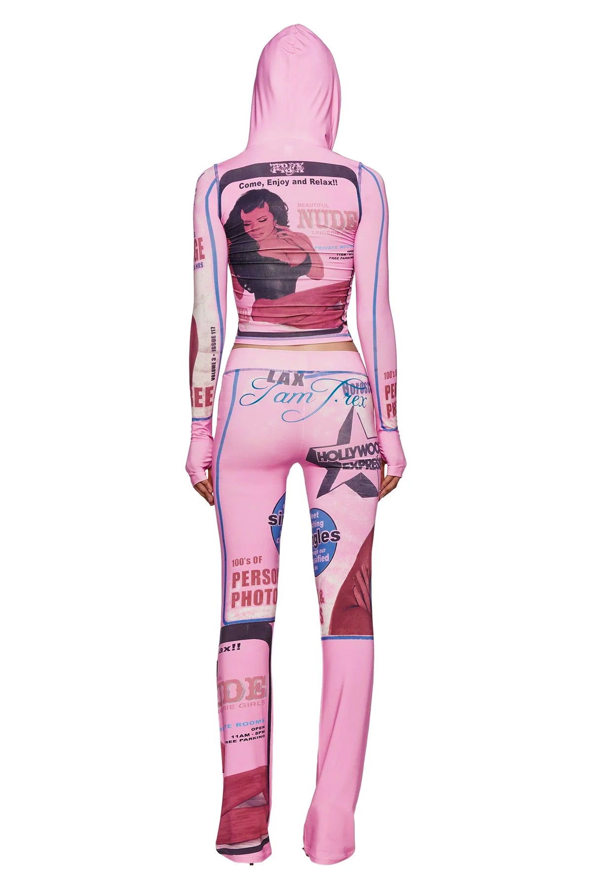 Model shown from the back wearing the I.AM.GIA T-REX BLARE TRACKPANT in pink, featuring bold vintage pin-up graphics, text, and magazine cover prints all over—capturing the signature I.AM.GIA aesthetic.
