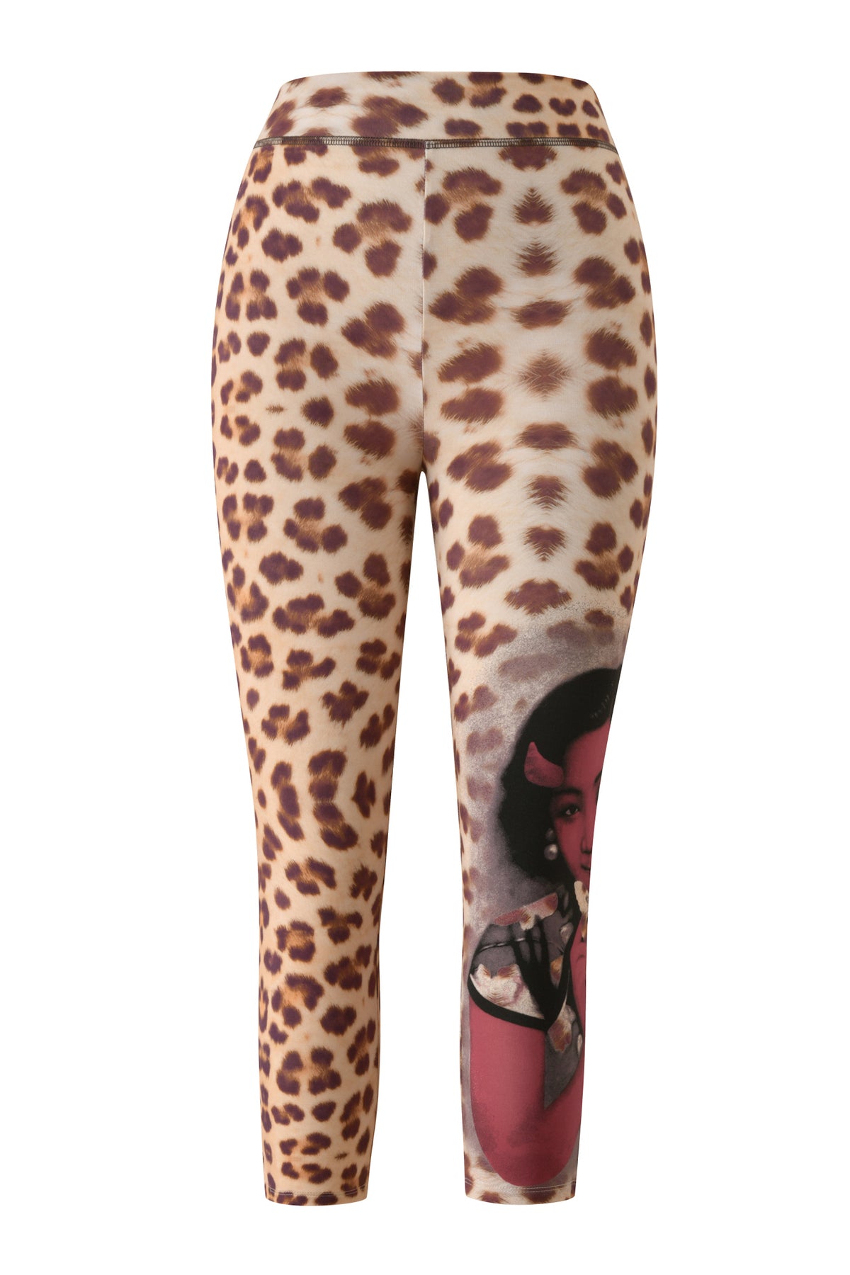 I.AM.GIA's T-REX BLARE CAPRI - WILD CARD leggings feature a leopard print design with a bodycon fit and cropped length, accented by an illustration of a woman in red tones near the knee on one leg.