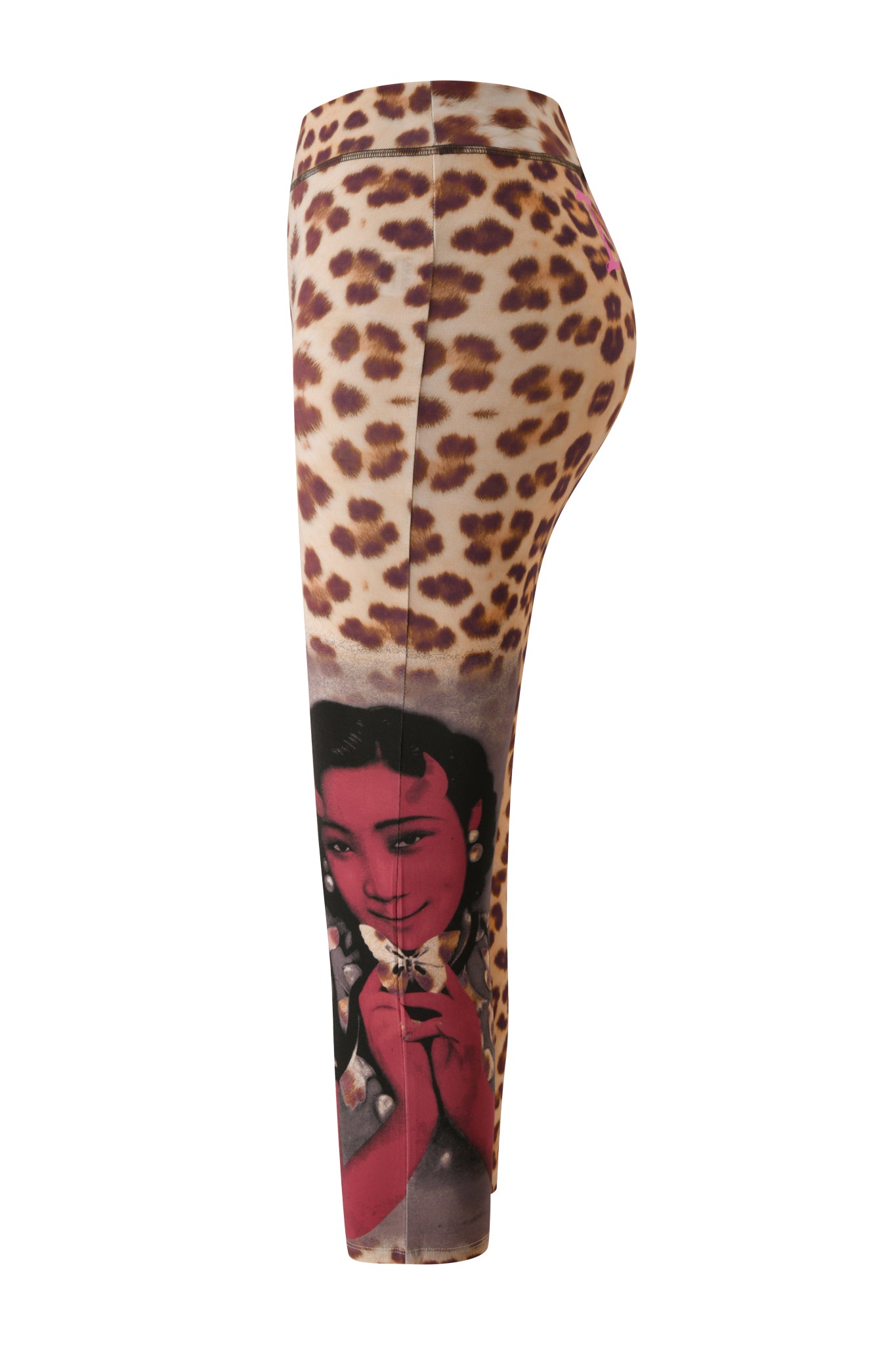 Introducing the T-REX BLARE CAPRI - WILD CARD by I.AM.GIA: these statement leggings feature a striking leopard print and a graphic vintage-style portrait of a woman holding a flower on the lower leg, blending boldness and artistry in true I.AM.GIA fashion for a uniquely eye-catching look.
