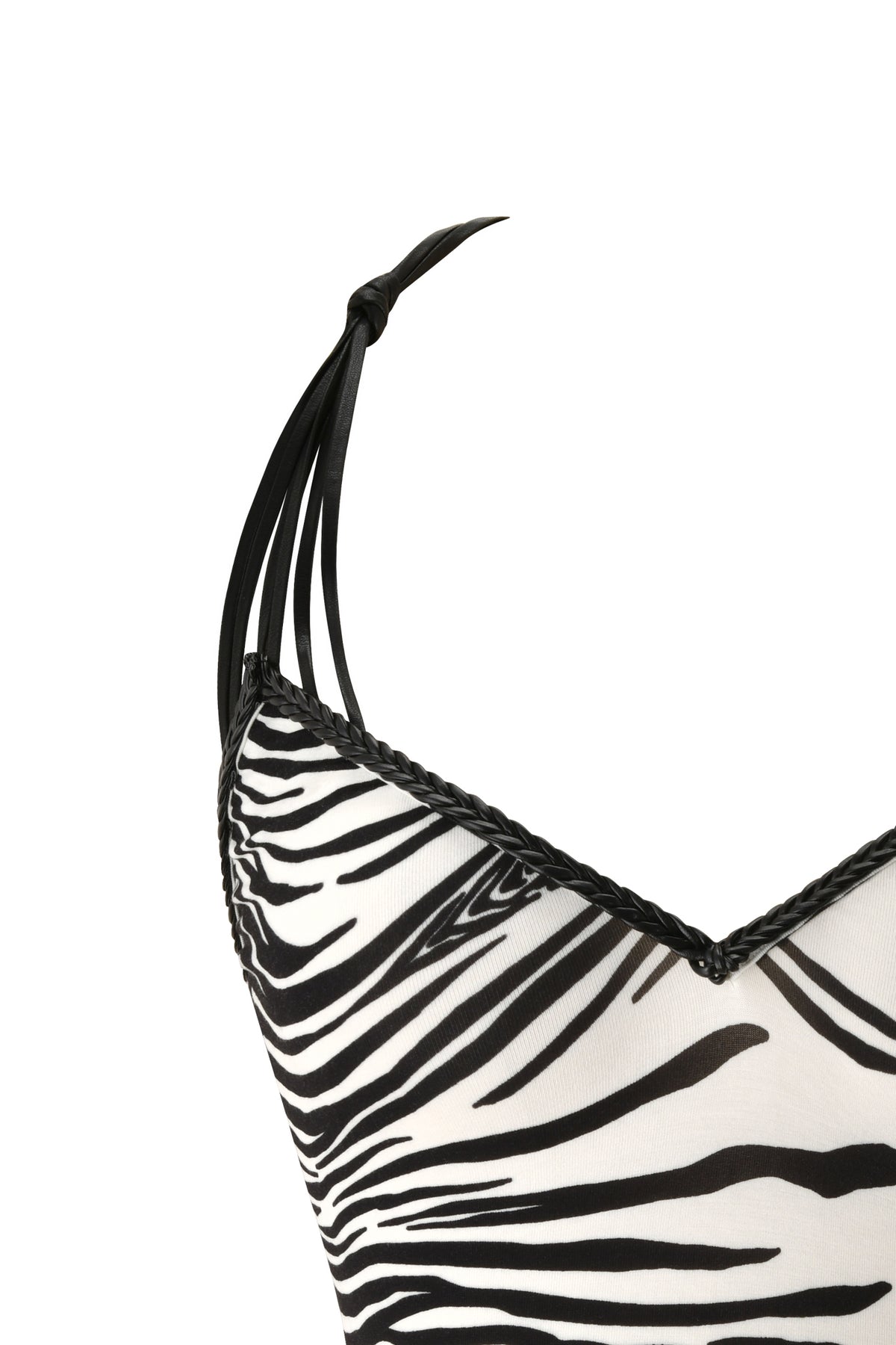 Close-up of the SYD TOP - FINE LINE ZEBRA by I.AM.GIA, a zebra print camisole with thin black shoulder straps that can be tied for a custom fit and finished with black braided trim along the neckline. This bold top features a chic, low-back design, making it a standout addition to your look.