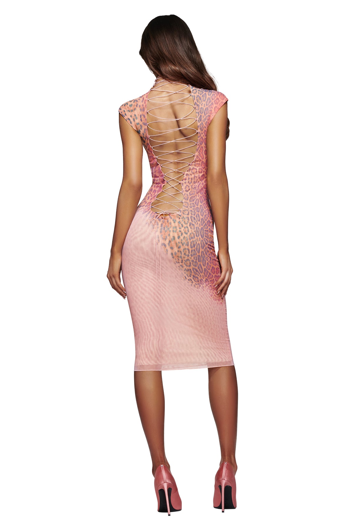 A woman wearing the I.AM.GIA ZOYA MIDI DRESS in Pink Faded Panthera—an animal-print, bodycon style with a lace-up open back—stands in high heels, facing away from the camera against a white background.