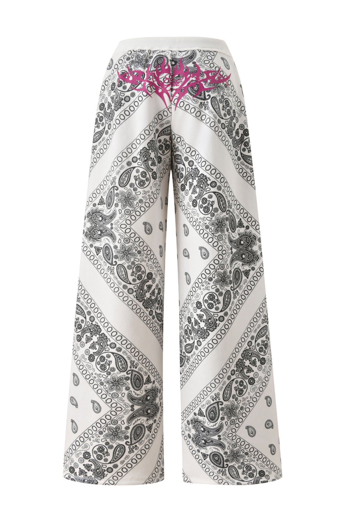 The T-REX TRACKPANT - PAISLEY by I.AM.GIA features white wide legs, a black paisley bandana print, and a bright pink detail on the back waistband—seen here from behind in this exclusive collaboration.