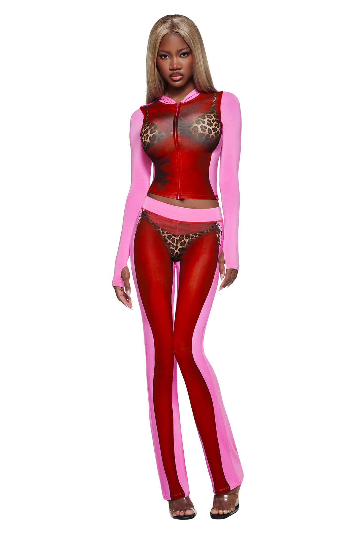 A woman models the I.AM.GIA T-REX SPRAY BODY BLARE HOODIE - PINK, featuring a sheer red and pink design with an airbrushed bikini body print, against a white background.