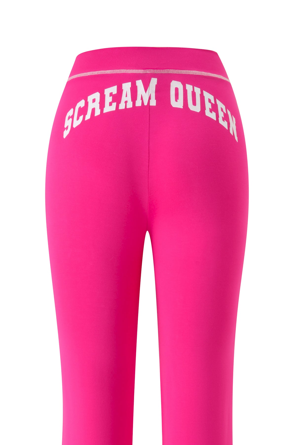 The I.AM.GIA BLARE TRACKPANT - HOT PINK SCREAM QUEEN leggings in vibrant hot pink are shown from the back, showcasing a striking white “SCREAM QUEEN” graphic across the waistband.
