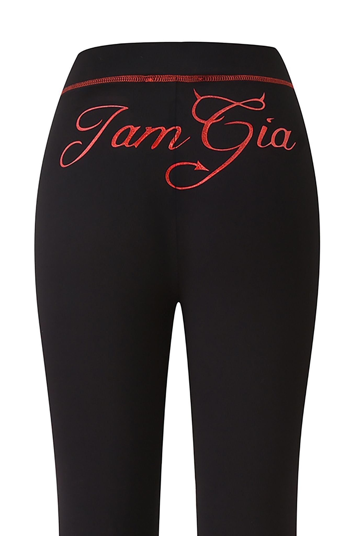 Close-up of the back of the black I.AM.GIA BLARE TRACKPANT - JET BLACK : DEVIL, featuring the devil GIA logo in large, red cursive lettering across the waistband.