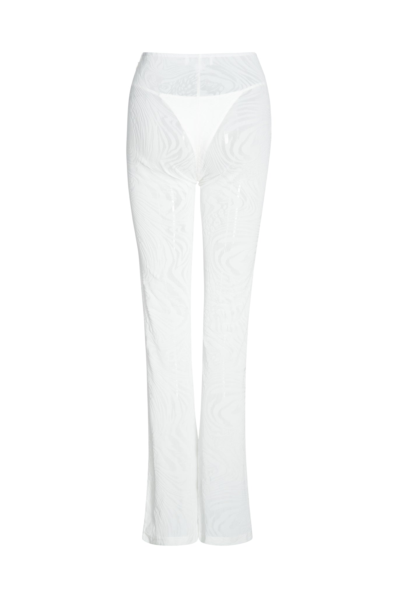 Introducing the AMINA PANT - WHITE by I.AM.GIA: These semi-transparent, lightweight white pants feature a delicate, swirling burnout velvet print. The mid-high rise design includes a slight flare at the bottom and reveals a white thong through the sheer mesh material. The image is captured against a plain white background.