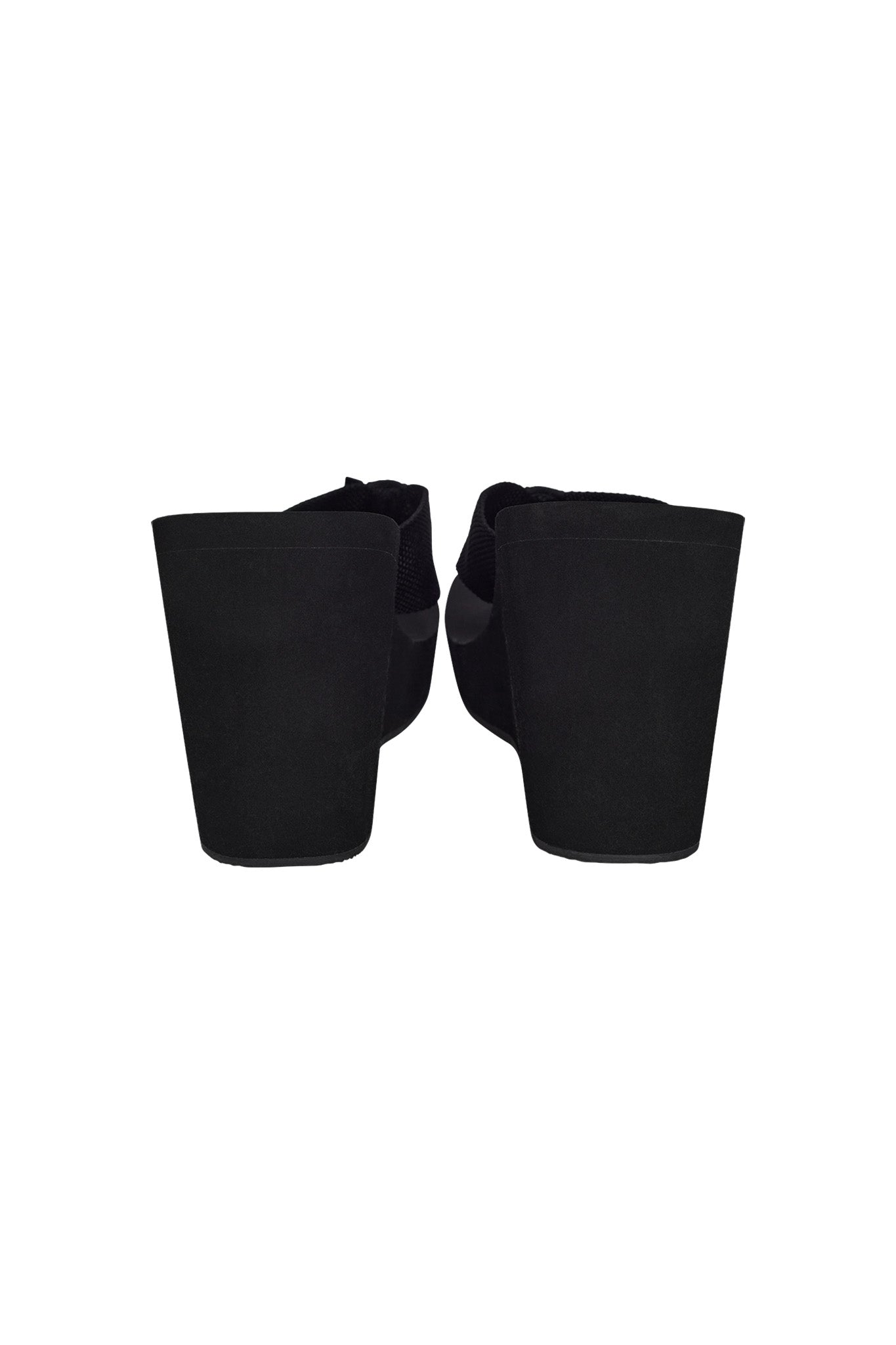 A pair of black platform wedge flip flops viewed from the back. The I.AM.GIA SHELBY FLIP FLOP features thick, solid heels and a smooth finish, providing a modern and stylish look.