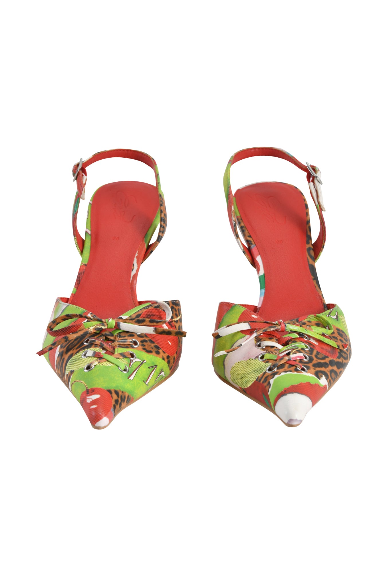 The I.AM.GIA NOORI MULE - WILD CHERRY is a faux leather kitten heel with a colorful Wild Cherry print, red, green, and leopard accents, red insoles, pointed toes, and front bow details.