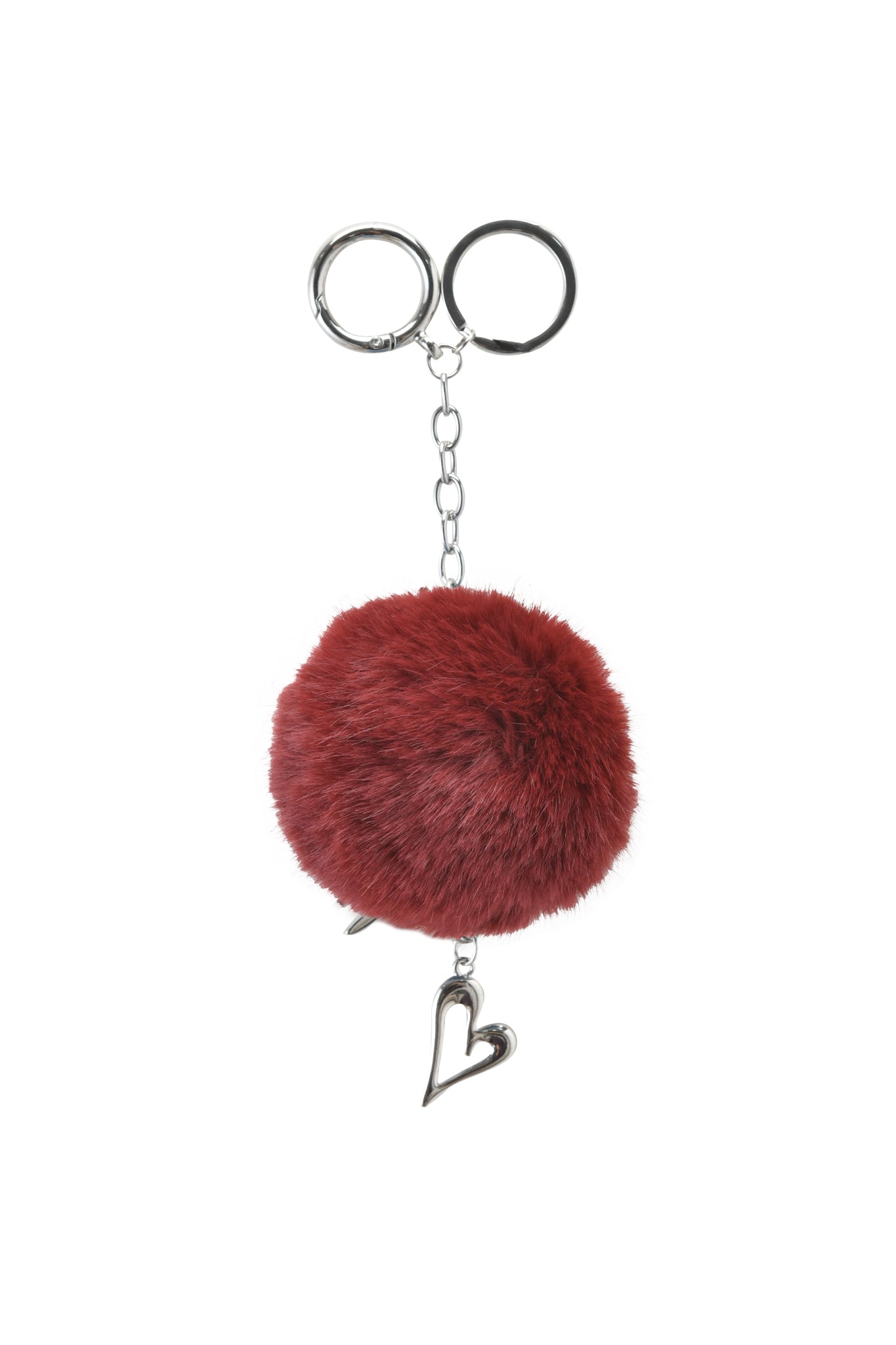 The LARSA KEYCHAIN - RED by I.AM.GIA features a deep red faux fur pom pom, silver chain, two key rings, and a dangling heart charm—ideal for adding style to your bag or keys.