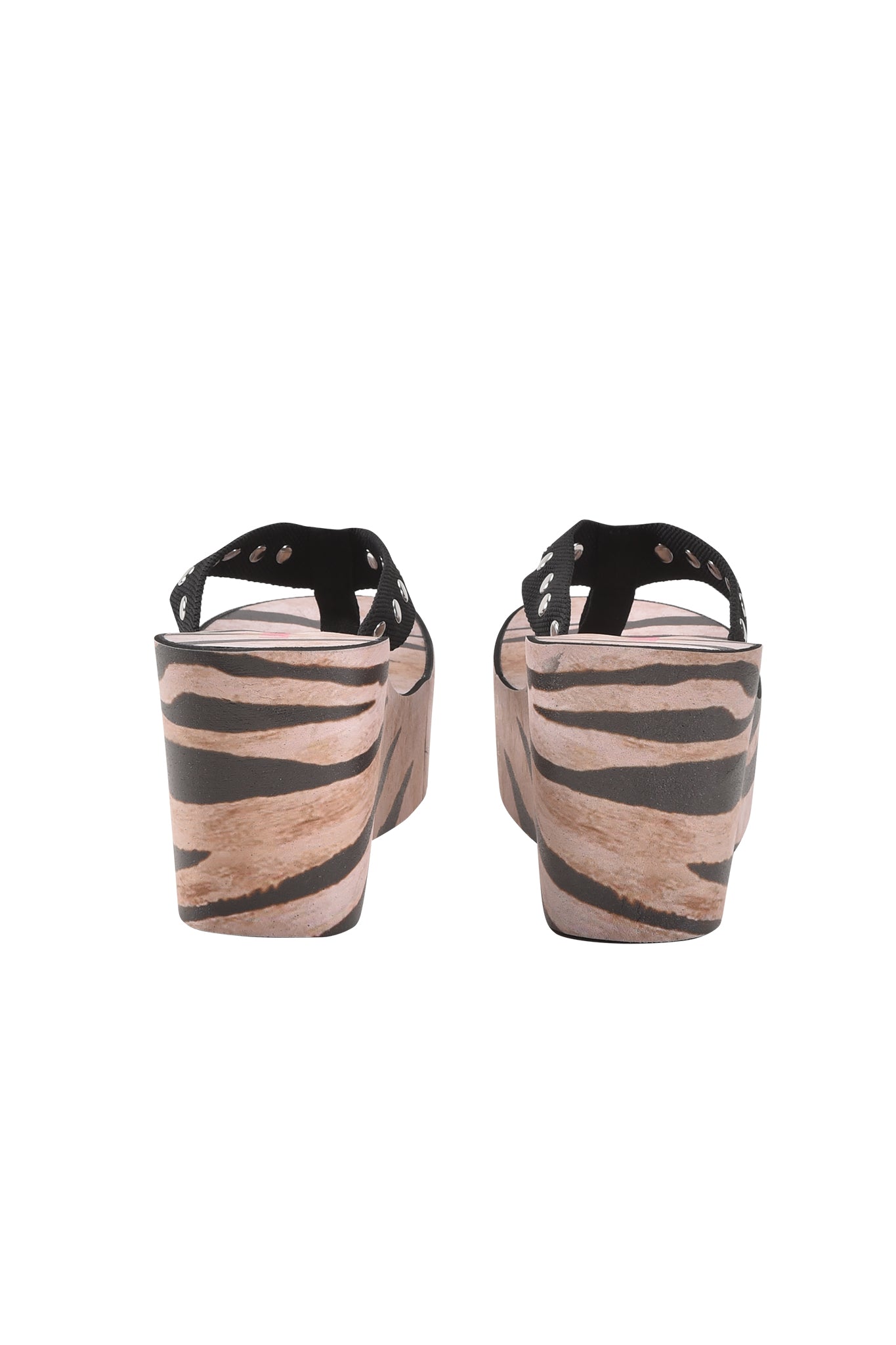 Back view of the I.AM.GIA SHELBY STUDDED FLIP FLOP 2.0 - WILD SIDE, showcasing black straps with silver studs and bold black and beige animal print wedge heels.