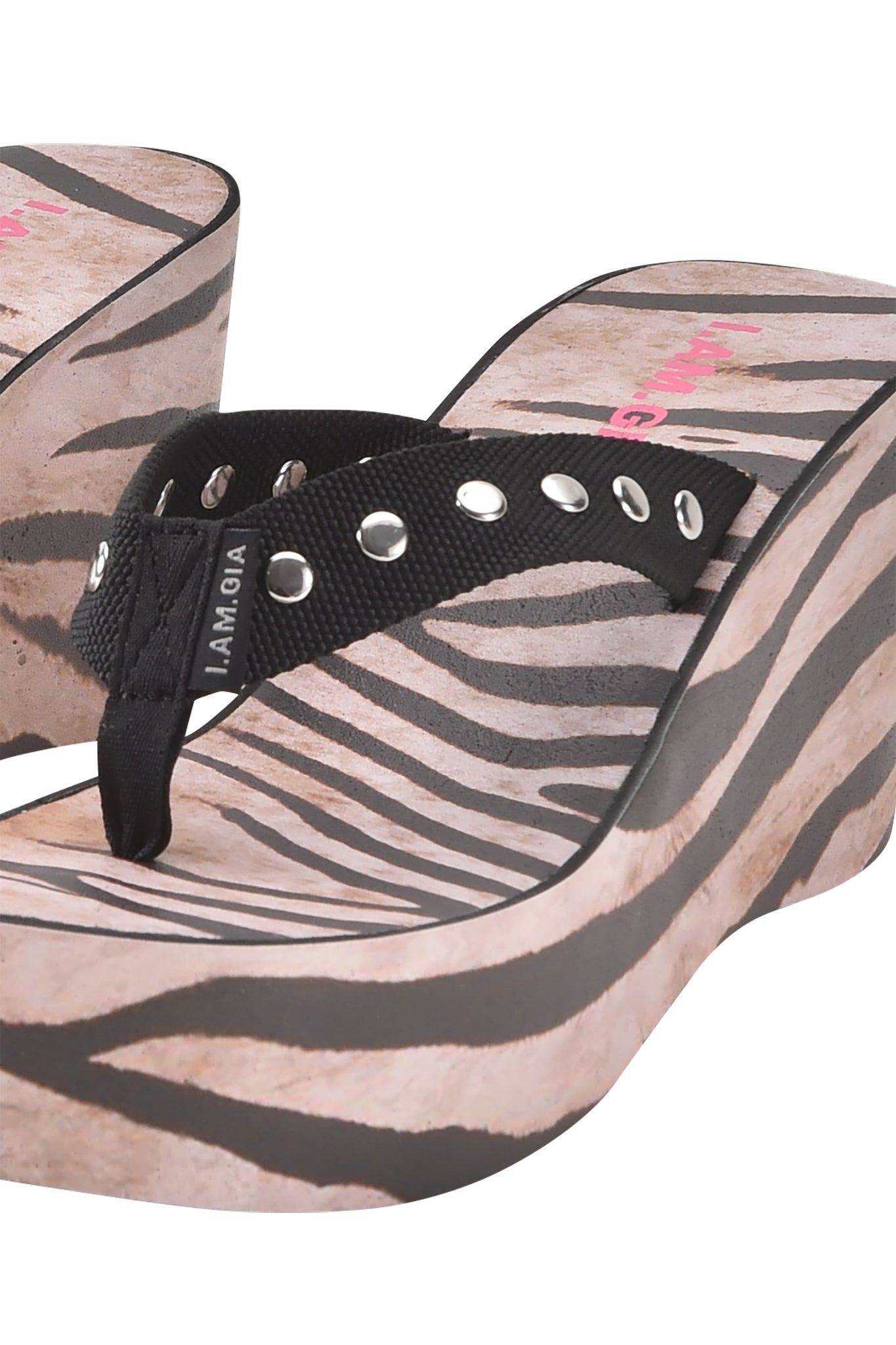Close-up of the I.AM.GIA SHELBY STUDDED FLIP FLOP 2.0 - WILD SIDE, a platform wedge sandal with a bold animal print and black fabric straps featuring metallic eyelets.