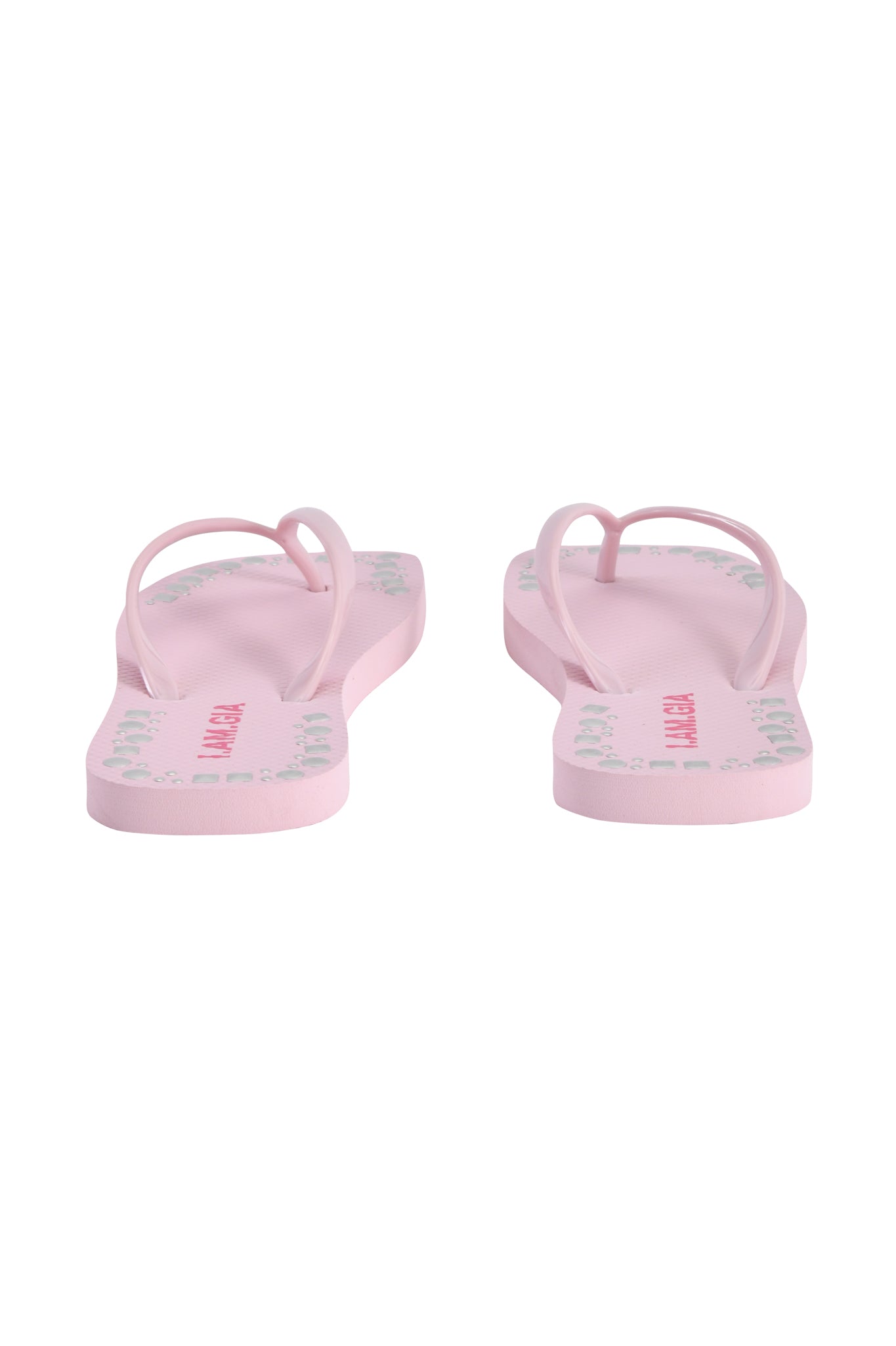 The INKA STUDDED FLIP FLOP by I.AM.GIA in baby pink is shown from the back, displaying pale straps and printed green and red designs on the soles against a white background.