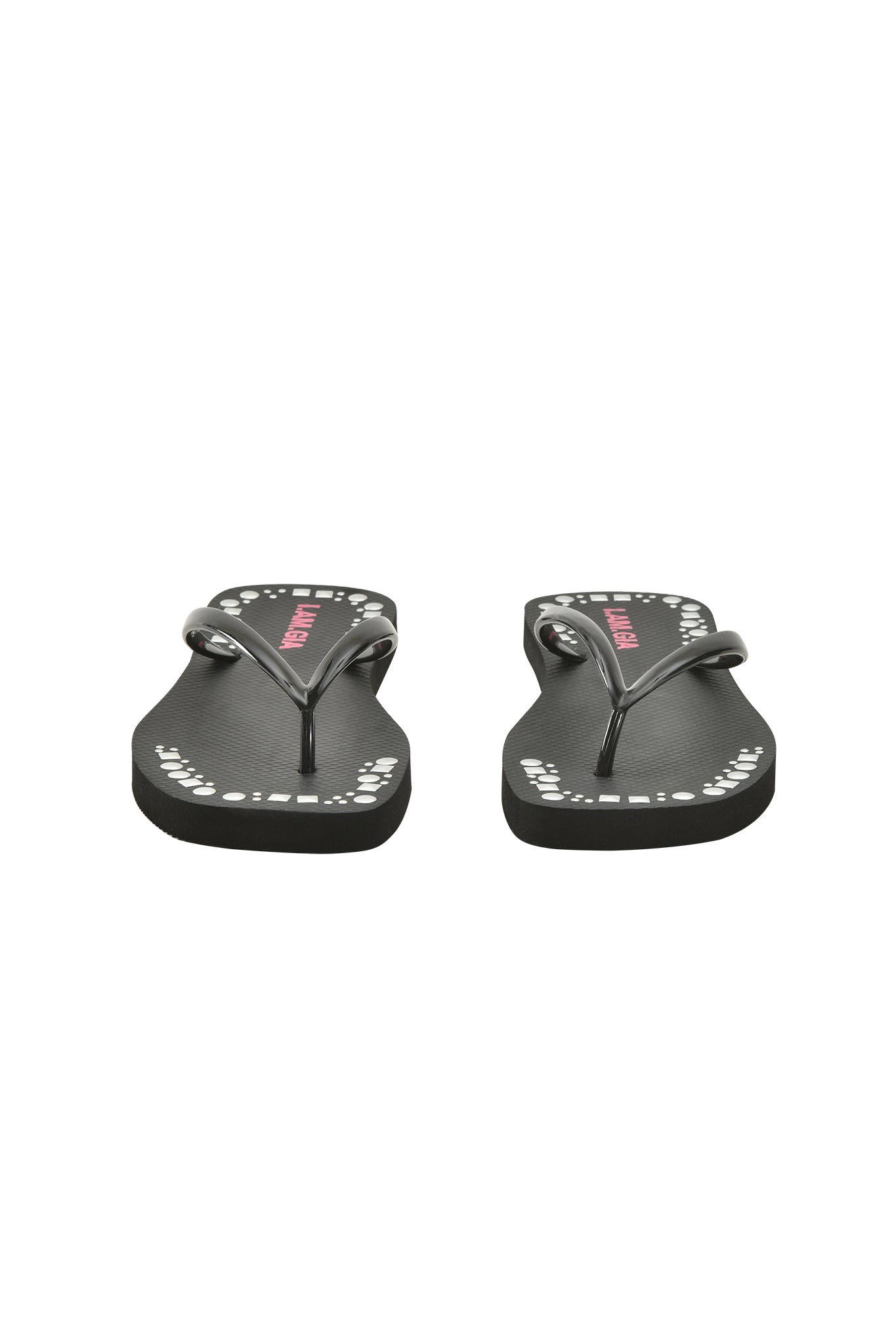 The INKA STUDDED FLIP FLOP - BLACK by I.AM.GIA features black straps with white dots and studs, an extra-soft foam footbed, and pink branding on the insoles, shown front-facing on a white background.
