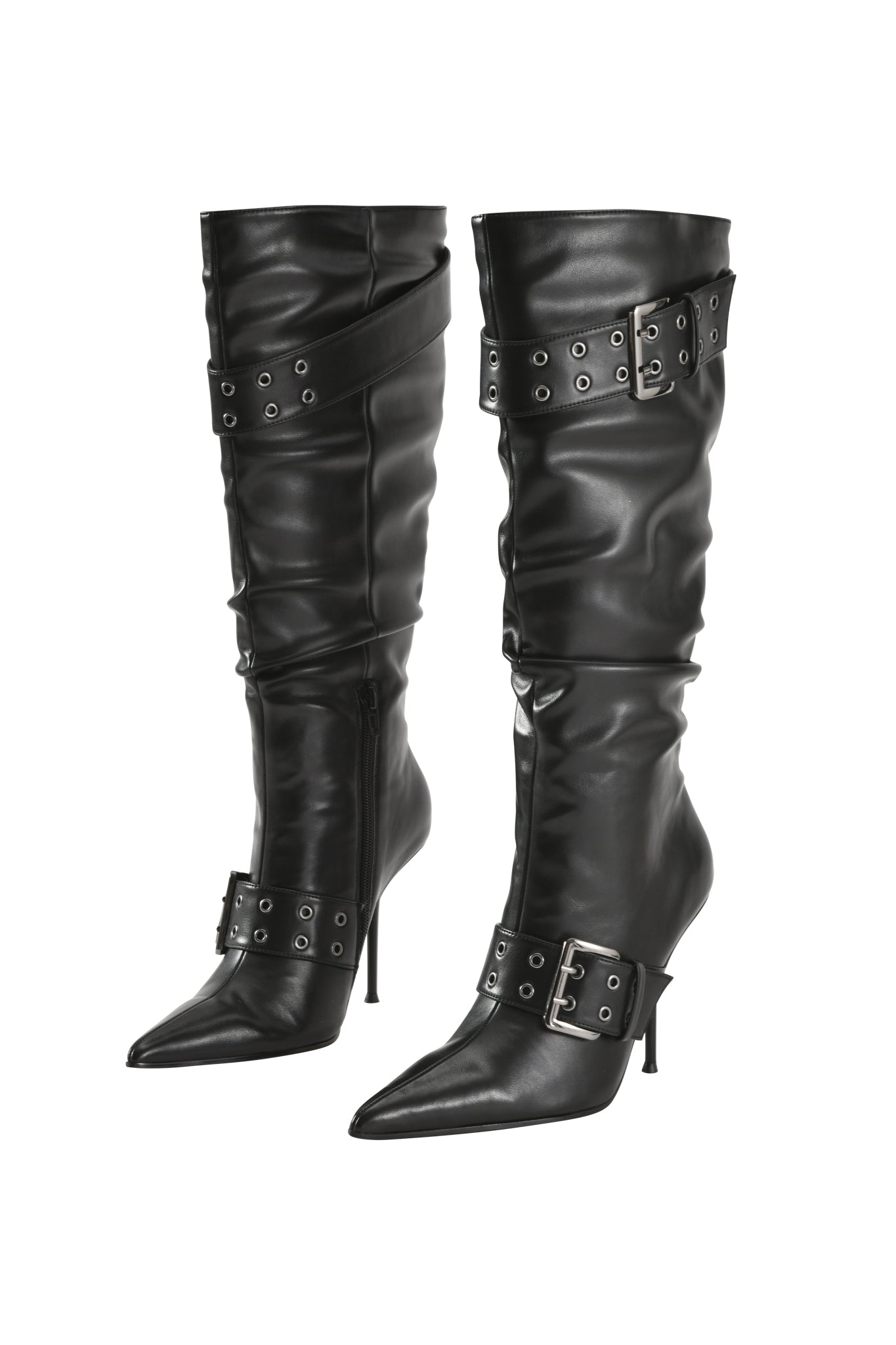 KINTH BOOT 2.0 - BLACK by I.AM.GIA is a pair of tall, black stiletto heel boots with pointed toes, decorative buckle straps, and slouchy faux-leather construction. Featuring straps adorned with metal eyelets and grommets, these knee-high boots make a modern statement with their sleek silhouette and bold details, beautifully displayed on a white background.