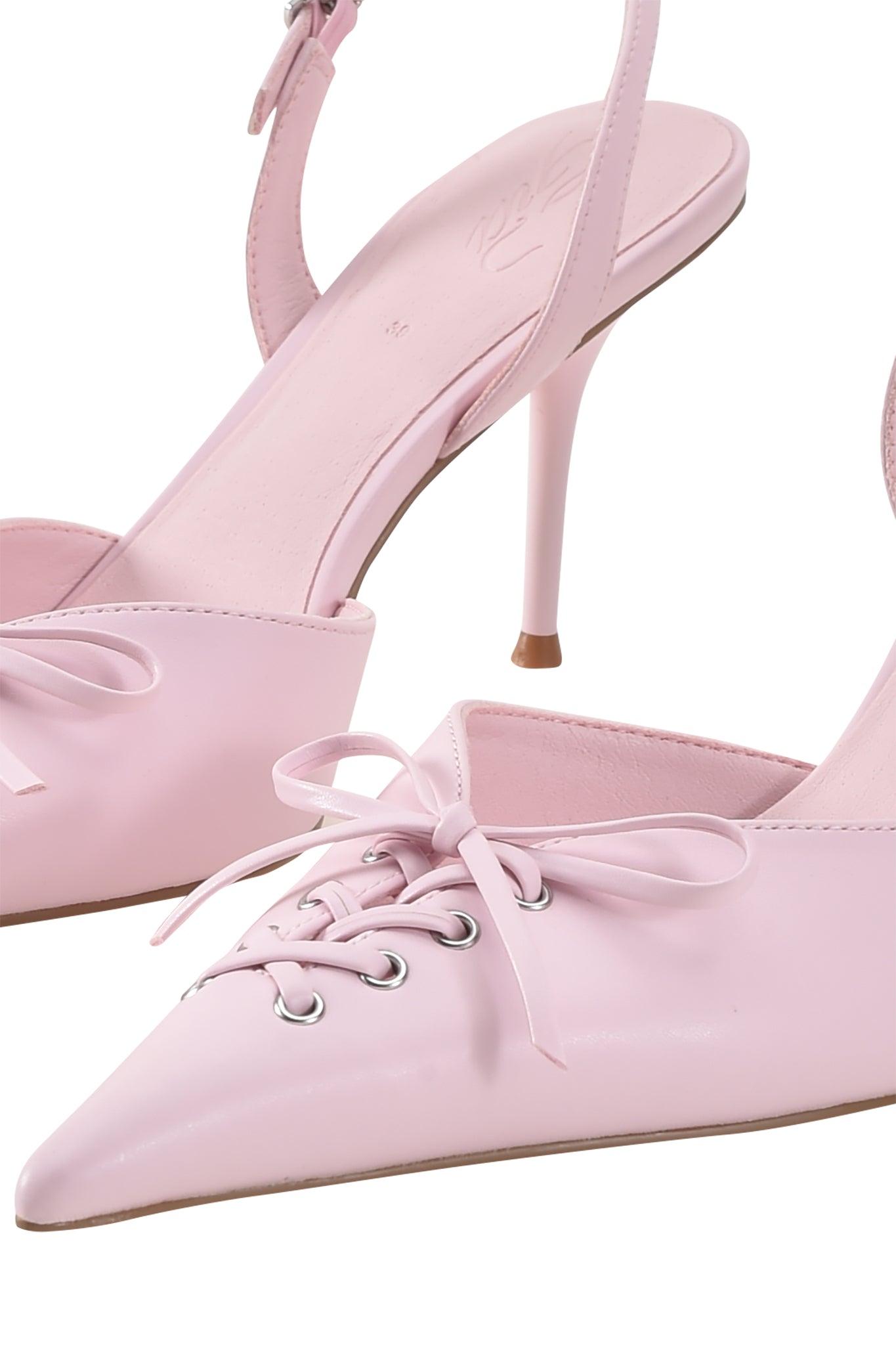 Close-up of the I.AM.GIA NOORI MULE in ice pink, featuring pointed toes, lace-up fronts, and a glossy faux leather finish with kitten heels.