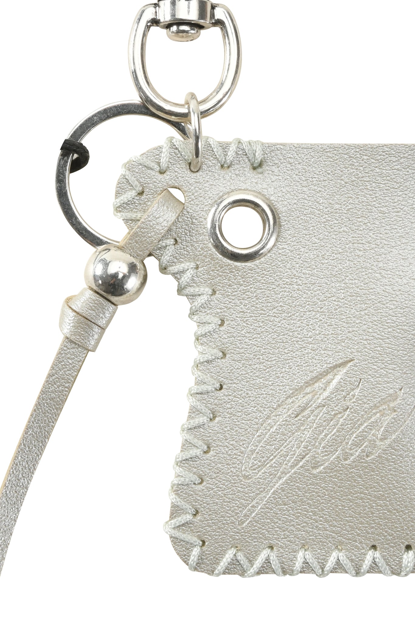 Close-up of the VENUS LIGHTER KEYCHAIN - SILVER by I.AM.GIA, featuring silver faux leather with decorative stitching, a metal grommet, lobster clasp, and an embossed I.AM.GIA logo on its textured surface.