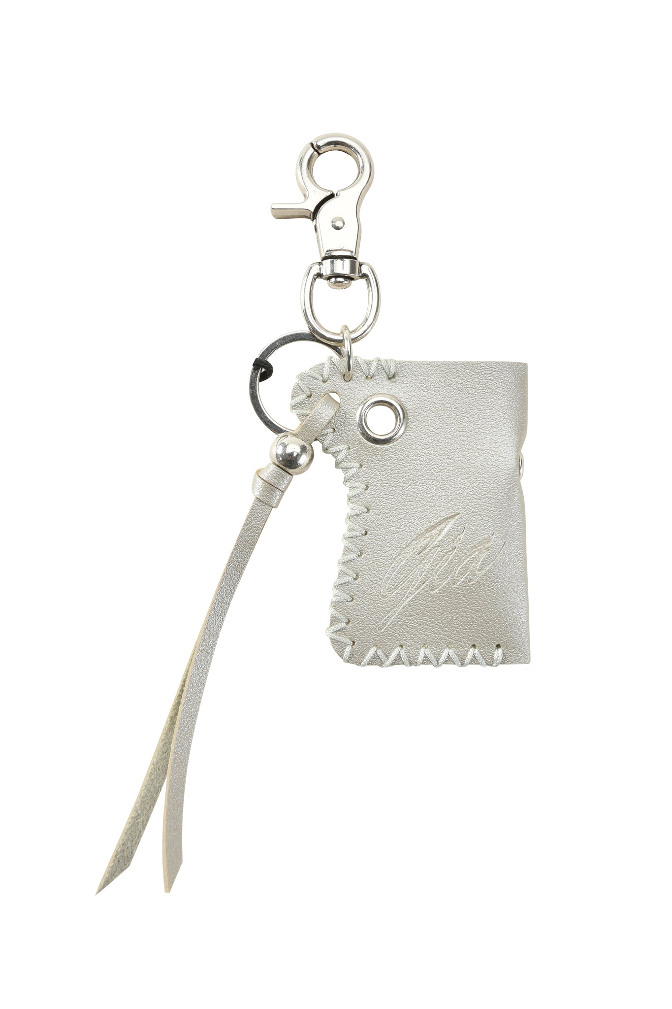 The VENUS LIGHTER KEYCHAIN by I.AM.GIA features silver faux leather with embossed signature design, zigzag stitching, a small tassel, and a metal clasp.