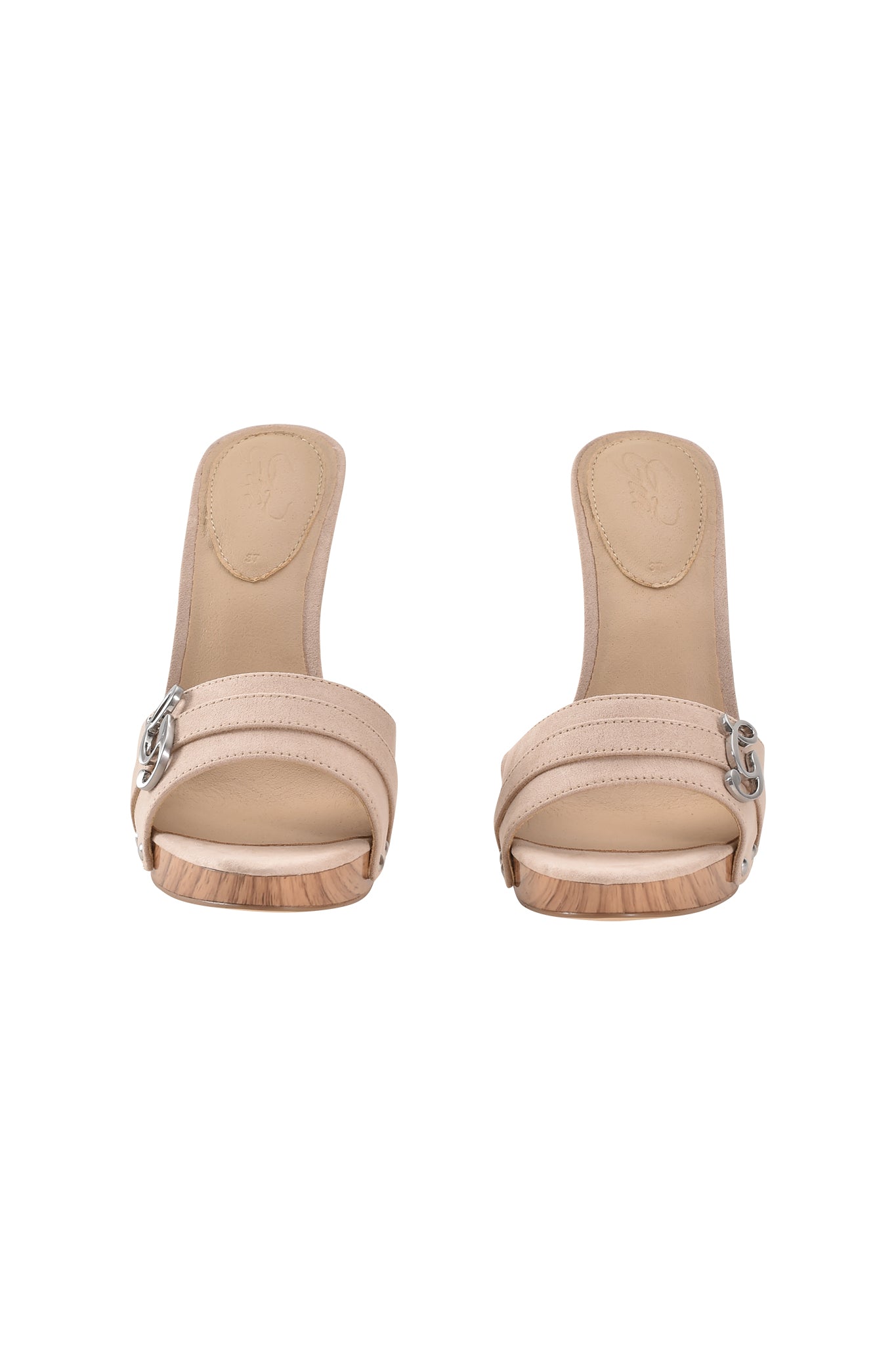The NICKY HEEL - TAN SUEDE by I.AM.GIA features tan faux suede stiletto mules with wooden soles and silver G hardware on the left strap, pictured on a white background.