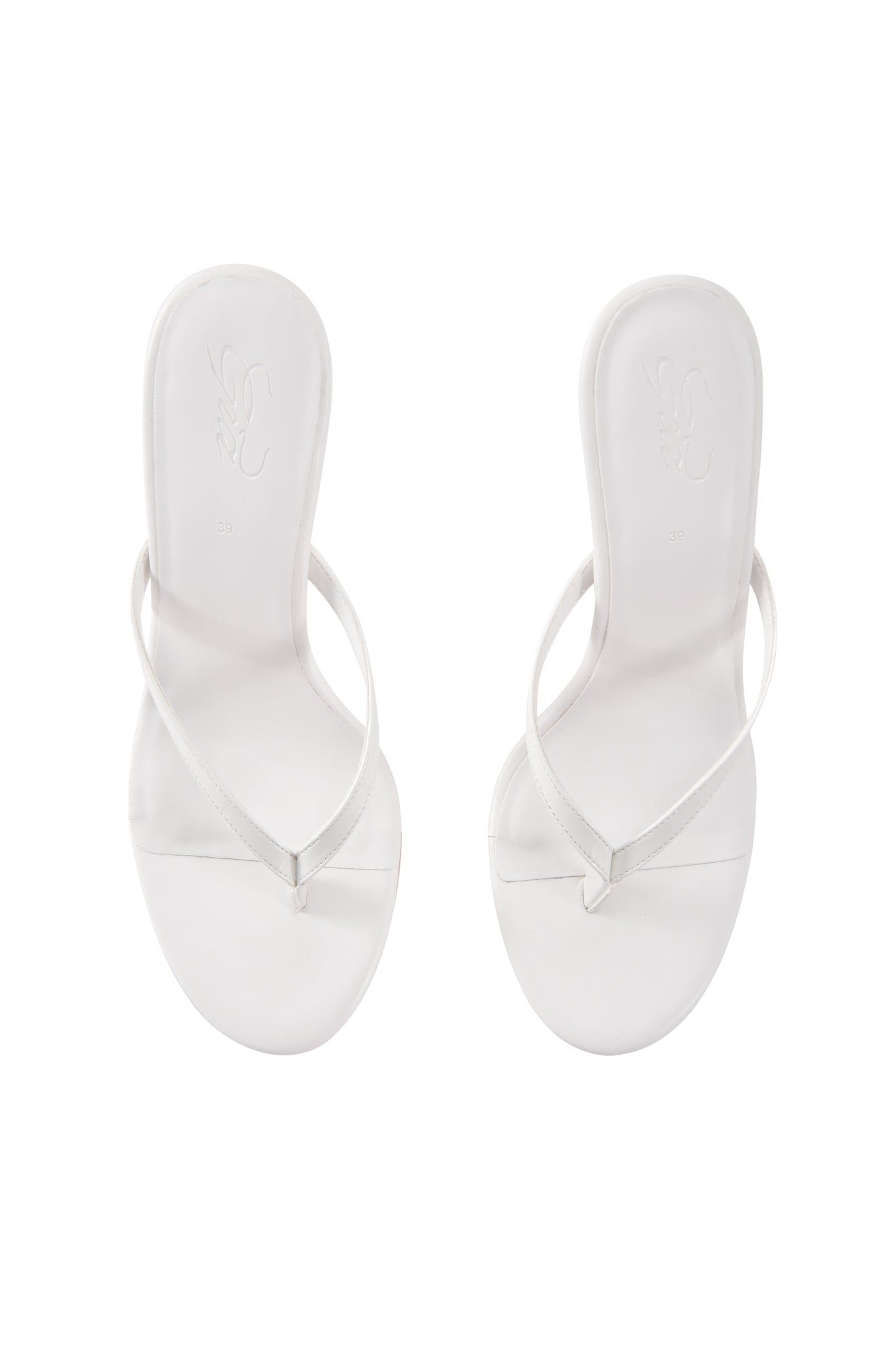 The I.AM.GIA VIKTORIA WEDGE HEEL in white features minimalist thong mule sandals with thin faux leather straps, shown from above on a plain white background.
