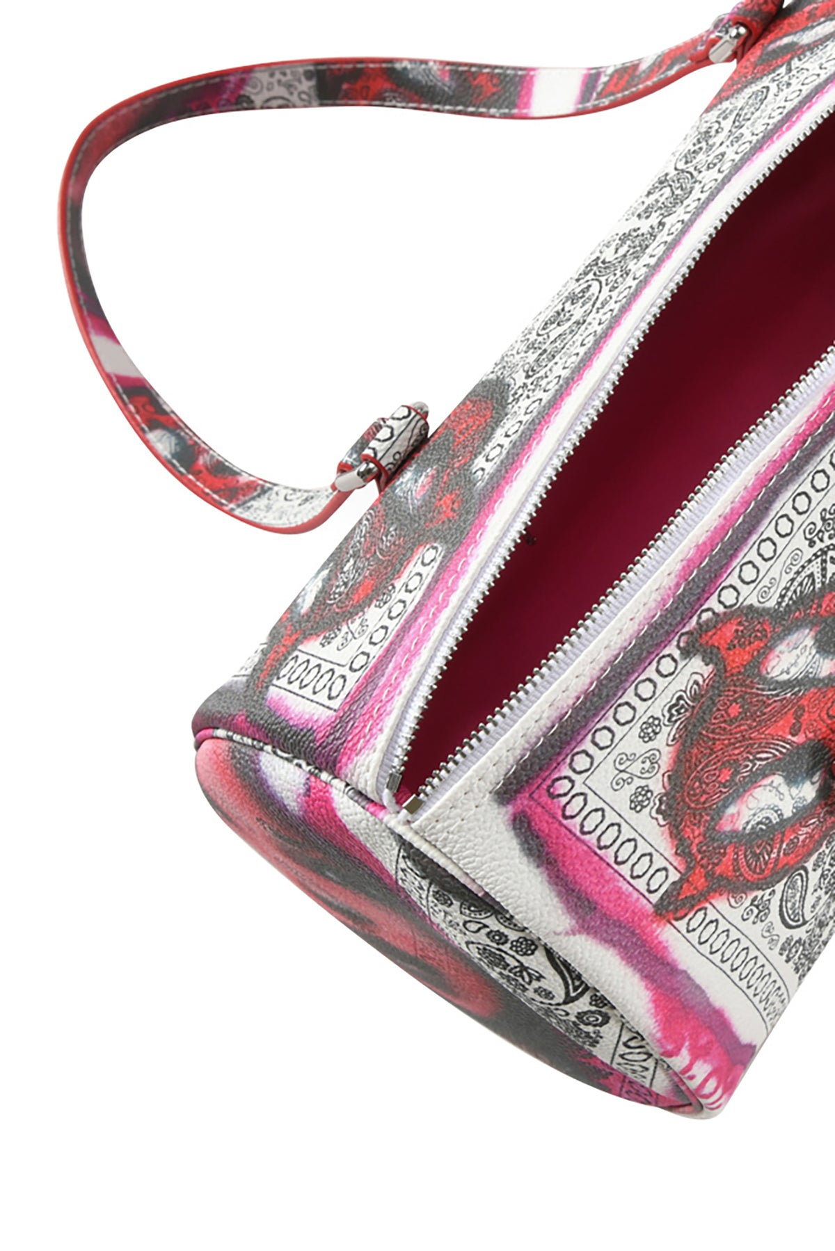 A close-up of the I.AM.GIA T-REX BARREL BAG - PAISLEY FACE in faux leather, featuring a pink, black, and white bandana print, partially unzipped to show its solid pink interior and matching strap.