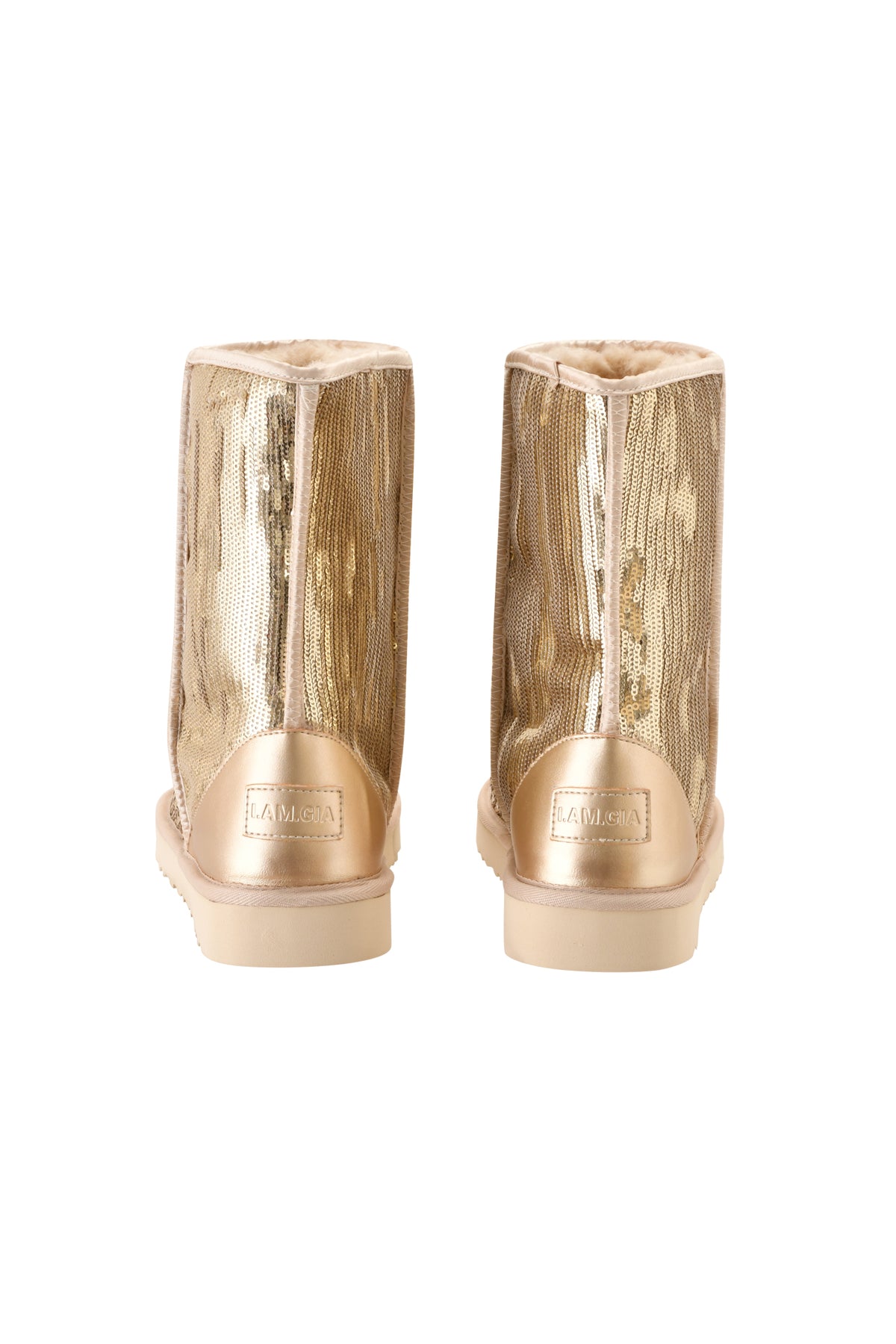 A pair of ELVIRA SEQUIN BOOT - GOLD mid-calf boots by I.AM.GIA is shown from the back, featuring a soft, plush faux fur lining and displaying the brand label on the heel.