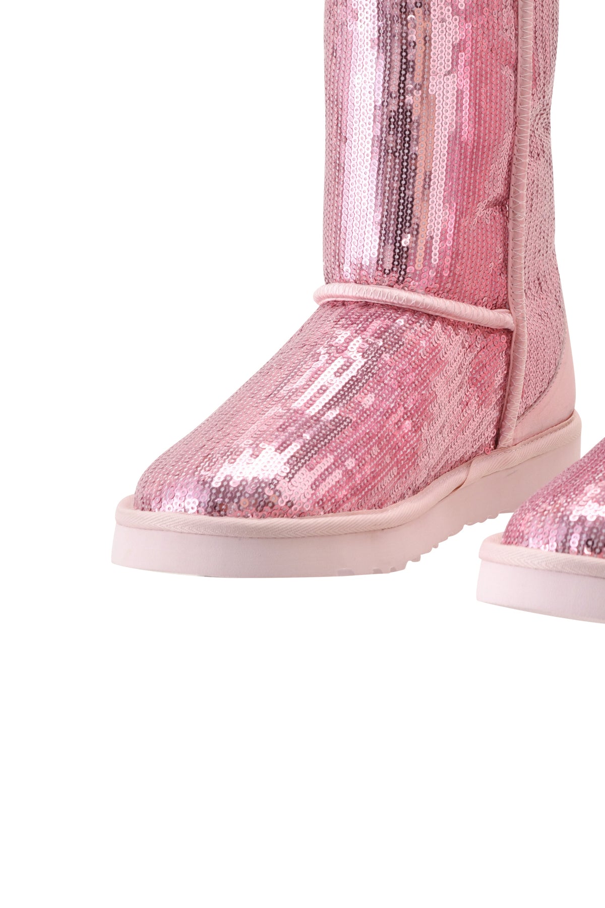 Close-up of the I.AM.GIA ELVIRA SEQUIN BOOT - PINK, featuring a sparkling pink sequin texture and soft, rounded shape. The image displays only the lower portion of these mid-calf boots against a white background, highlighting their eye-catching shine.