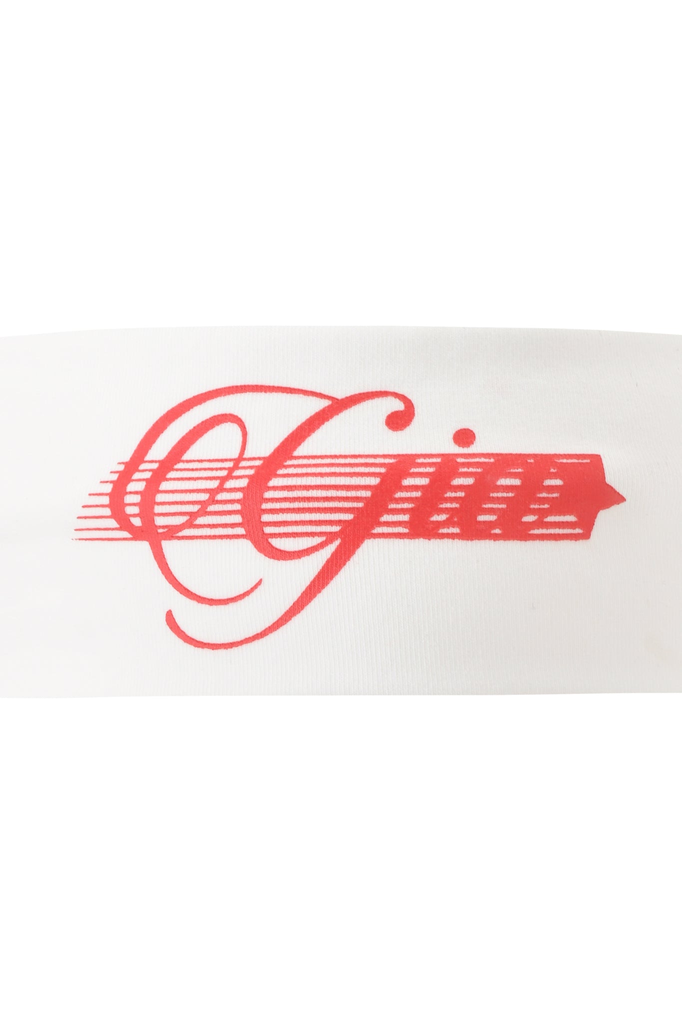 The NOVIA SPORT HEADBAND - WHITE by I.AM.GIA features red cursive "Gia" text with horizontal lines from the "G" ending in a star, printed on white stretch cotton.