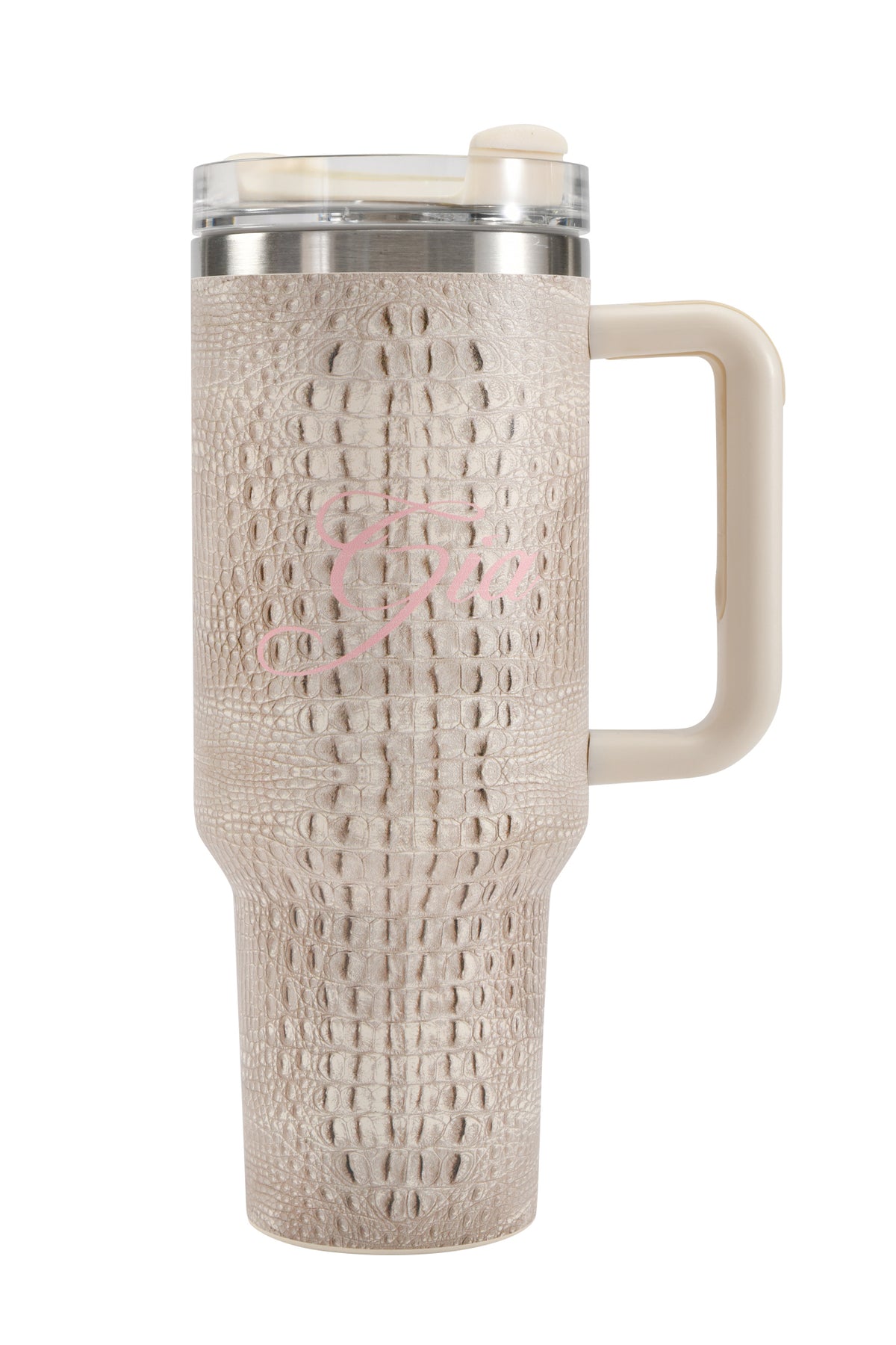 The BLARE CUP - HOT CROC by I.AM.GIA is a 40oz beige insulated stainless steel tumbler adorned with a bold crocodile skin pattern. It features a spacious handle for comfortable carrying, a clear slider lid, and a subtle pink cursive “G” elegantly displayed on the side.
