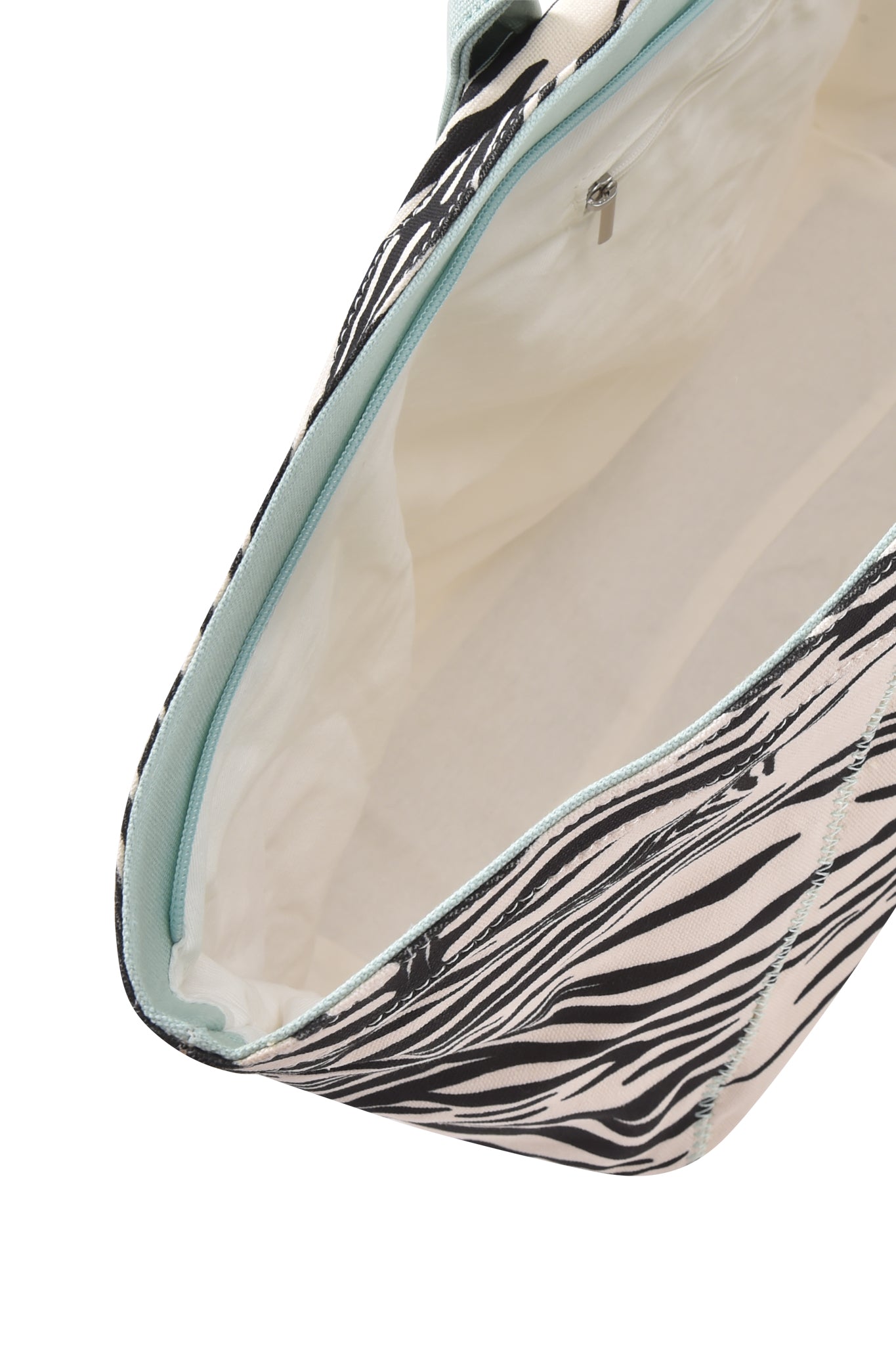 Discover the BLARE TOTE BAG - FINE LINE ZEBRA by I.AM.GIA: an open top view reveals its bold zebra print with sleek light blue trim and a roomy, light-colored interior—making it the perfect oversized shopper for carrying all your essentials.