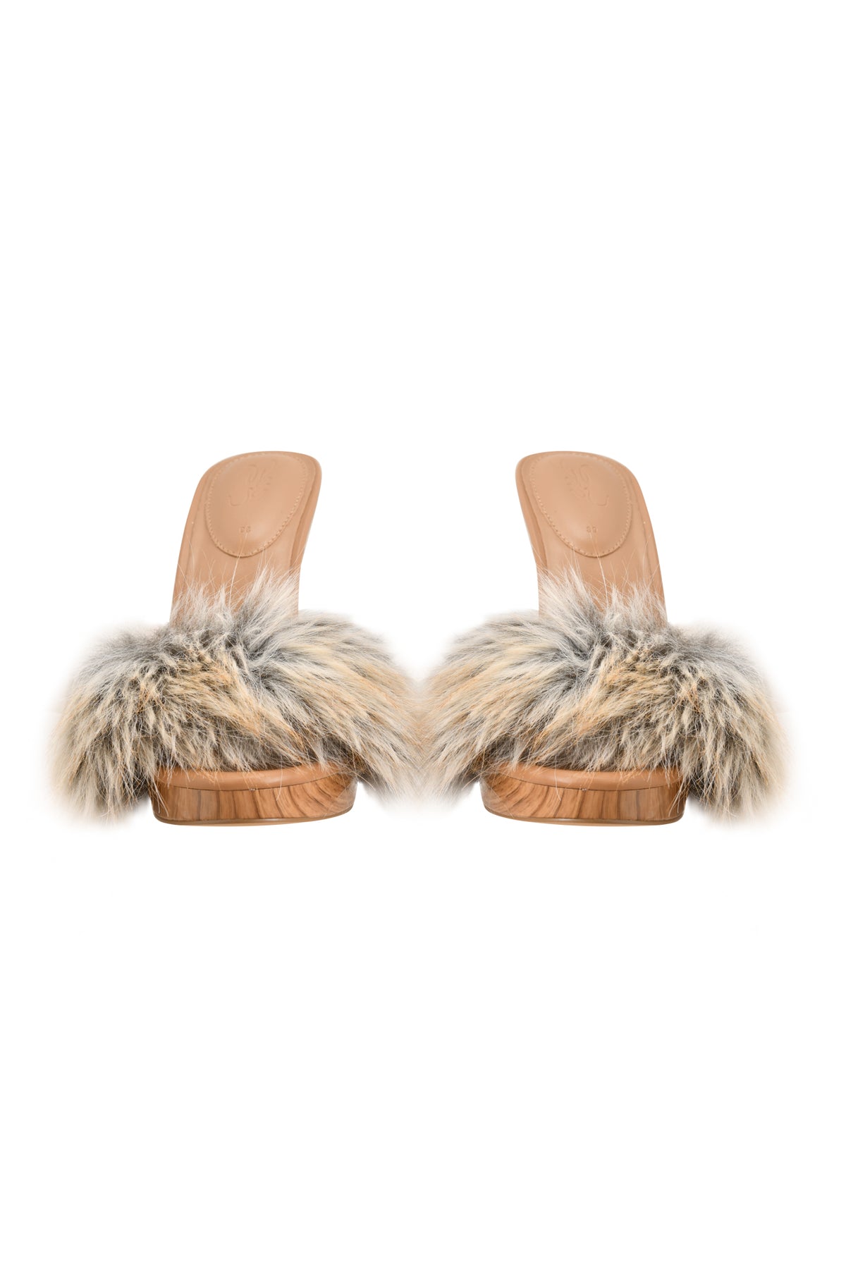 A pair of NICKY HEEL - FAUX FUR TAN mule sandals by I.AM.GIA, featuring wooden slip-on soles in tan and soft, multicolored faux fur straps, displayed from the front against a white background.