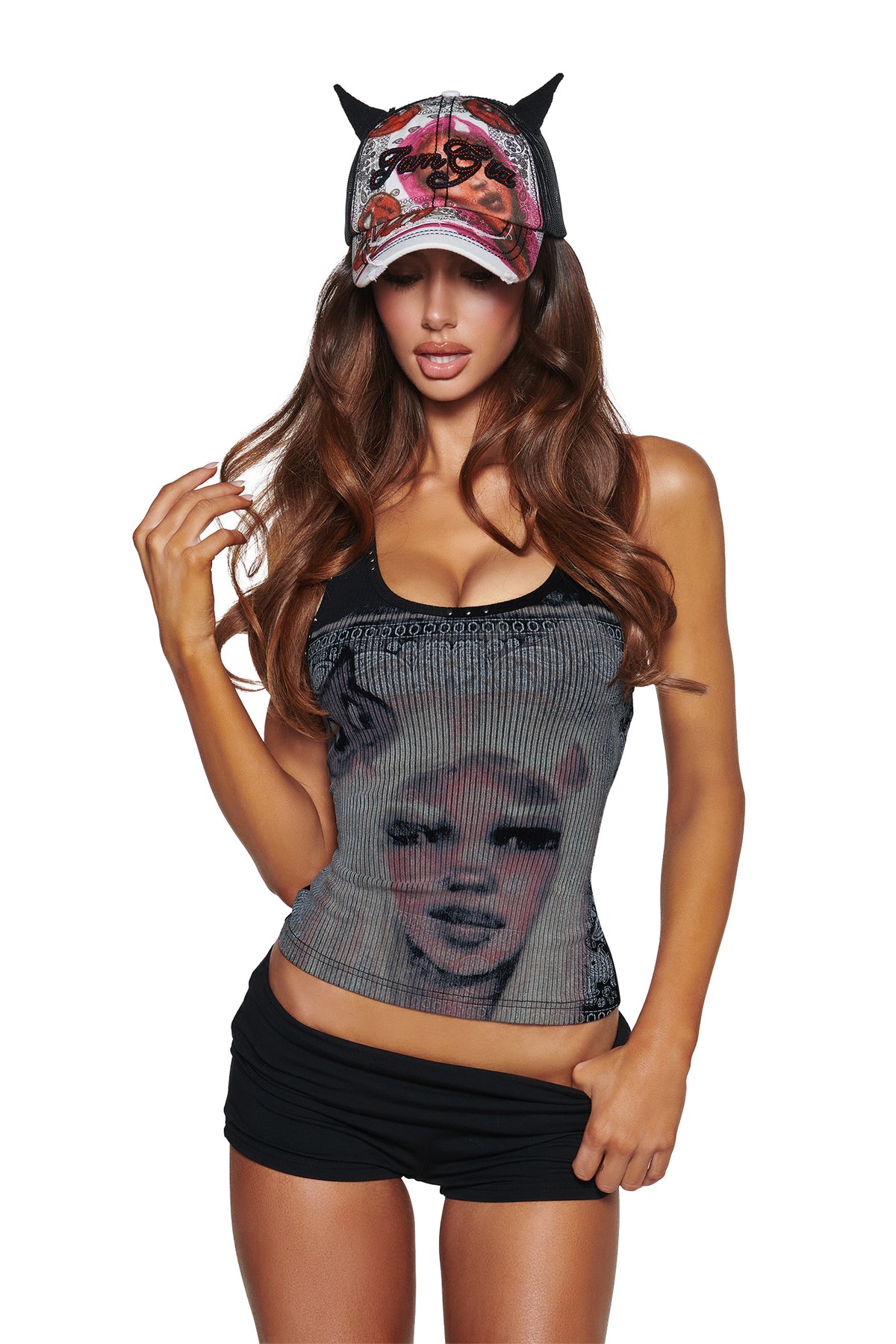 A woman in the I.AM.GIA T-REX DEVIL HAT - BLACK, a black printed face tank, and black shorts poses against a white background.