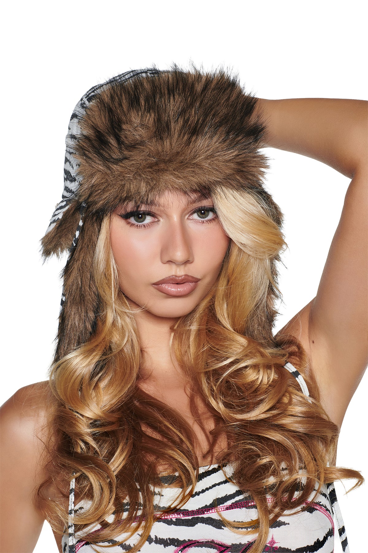 A person wearing an I.AM.GIA YVL FUR TRAPPER HAT - ZEBRA featuring a brown faux fur brim and black and white zebra print panels.