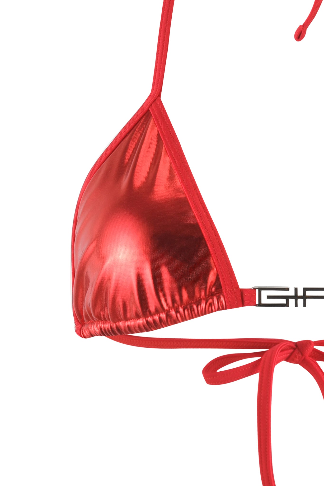 A close-up of the ALOHI BIKINI TOP - RED from I.AM.GIA is shown. The fabric boasts a metallic sheen and is designed with thin straps. The right side features a tie strap, while the left side displays part of the I.AM.GIA logo in black.