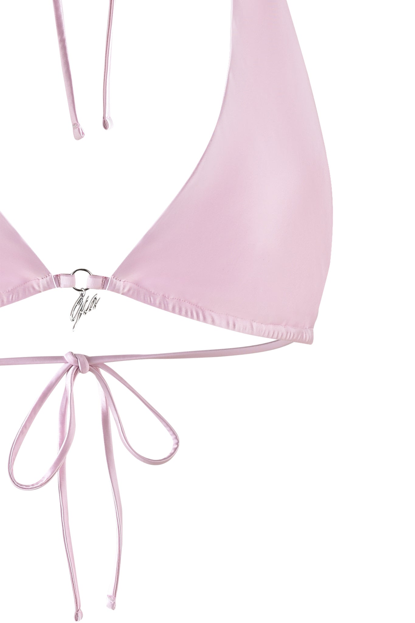 Close-up of the PUKA BIKINI TOP - PINK : PASTEL PINK by I.AM.GIA, featuring triangular cups and adjustable neck and back straps. The smooth and shiny fabric is accentuated by a metal ring at the center joining the cups. Loose strings tied in a bow are visible at the bottom of the image.